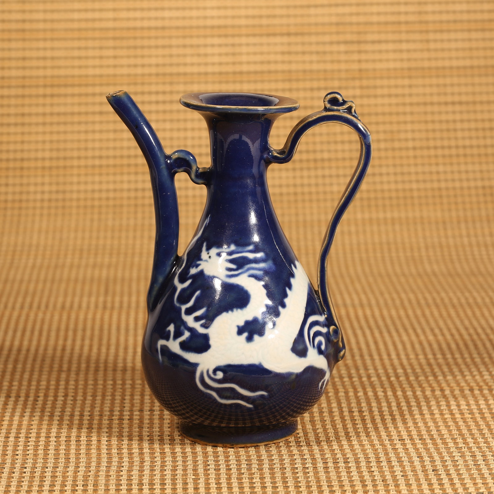 A YUAN DYNASTY JI-BLUE GLAZED EWER WITH RESERVED DRAGON MOTIF (1 of 8)