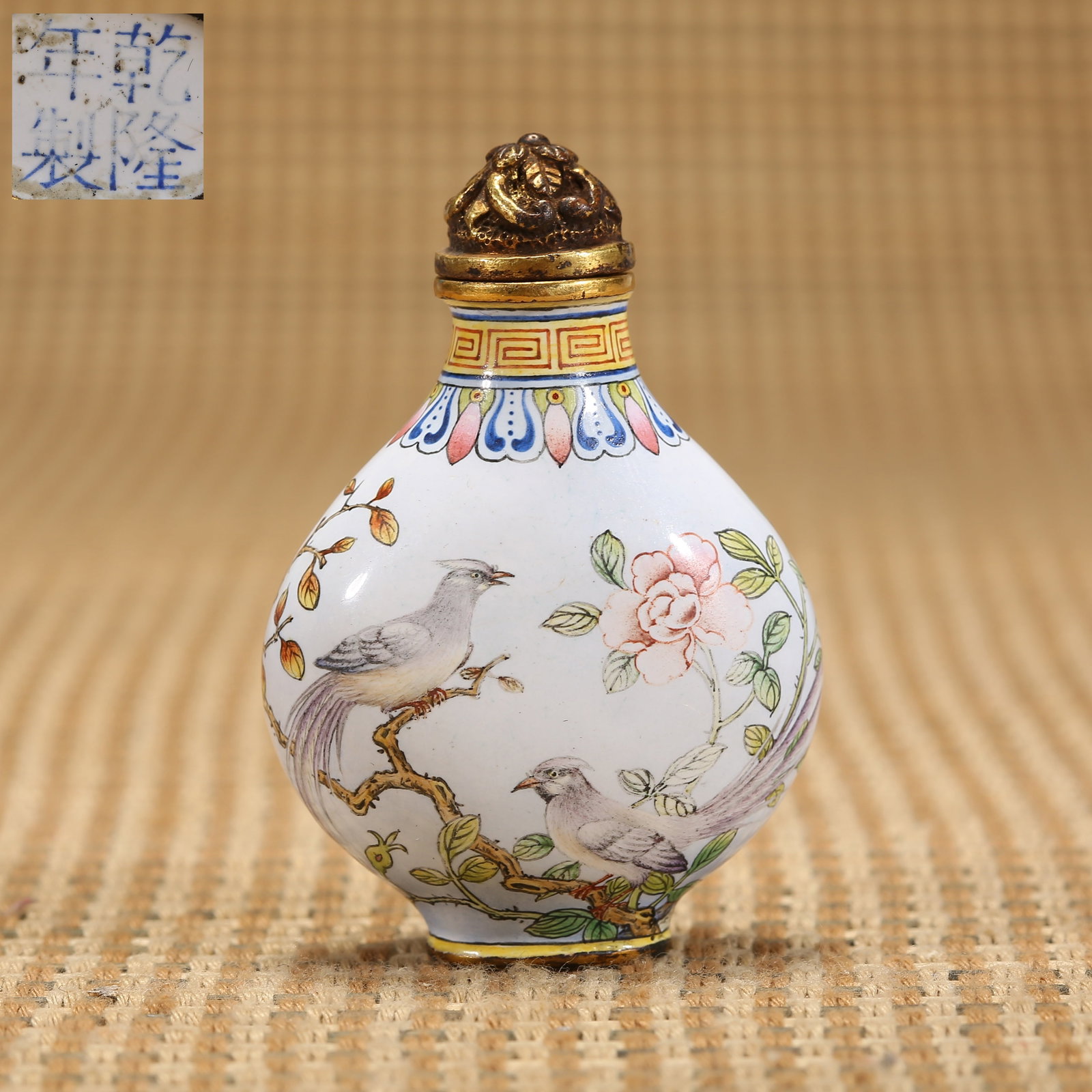 A QING DYNASTY QIANLONG PERIOD BRONZE-BODIED ENAMEL-PAINTED FLOWER-AND-BIRD SNUFF BOTTLE (1 of 9)