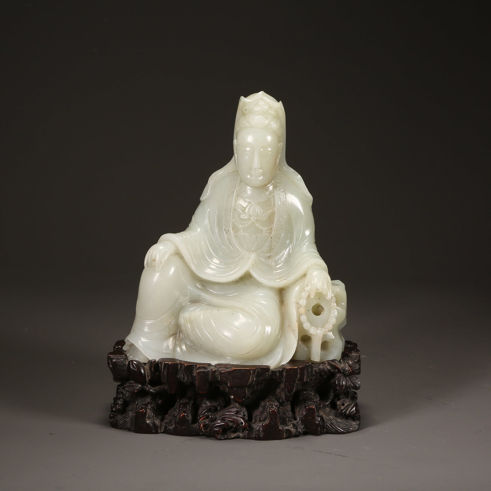 A QING DYNASTY HETIAN JADE SEATED GUANYIN (1 of 8)