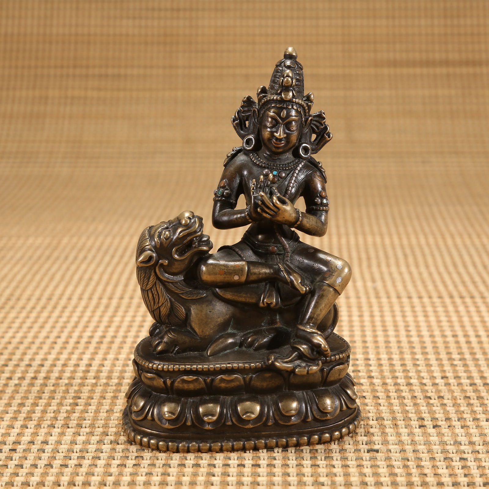 A 12TH CENTURY ALLOY BRONZE MANJUSHRI STATUE INLAID WITH SILVER AND RED BRONZE: 12th century alloy bronze Manjushri statue inlaid with silver and red bronze