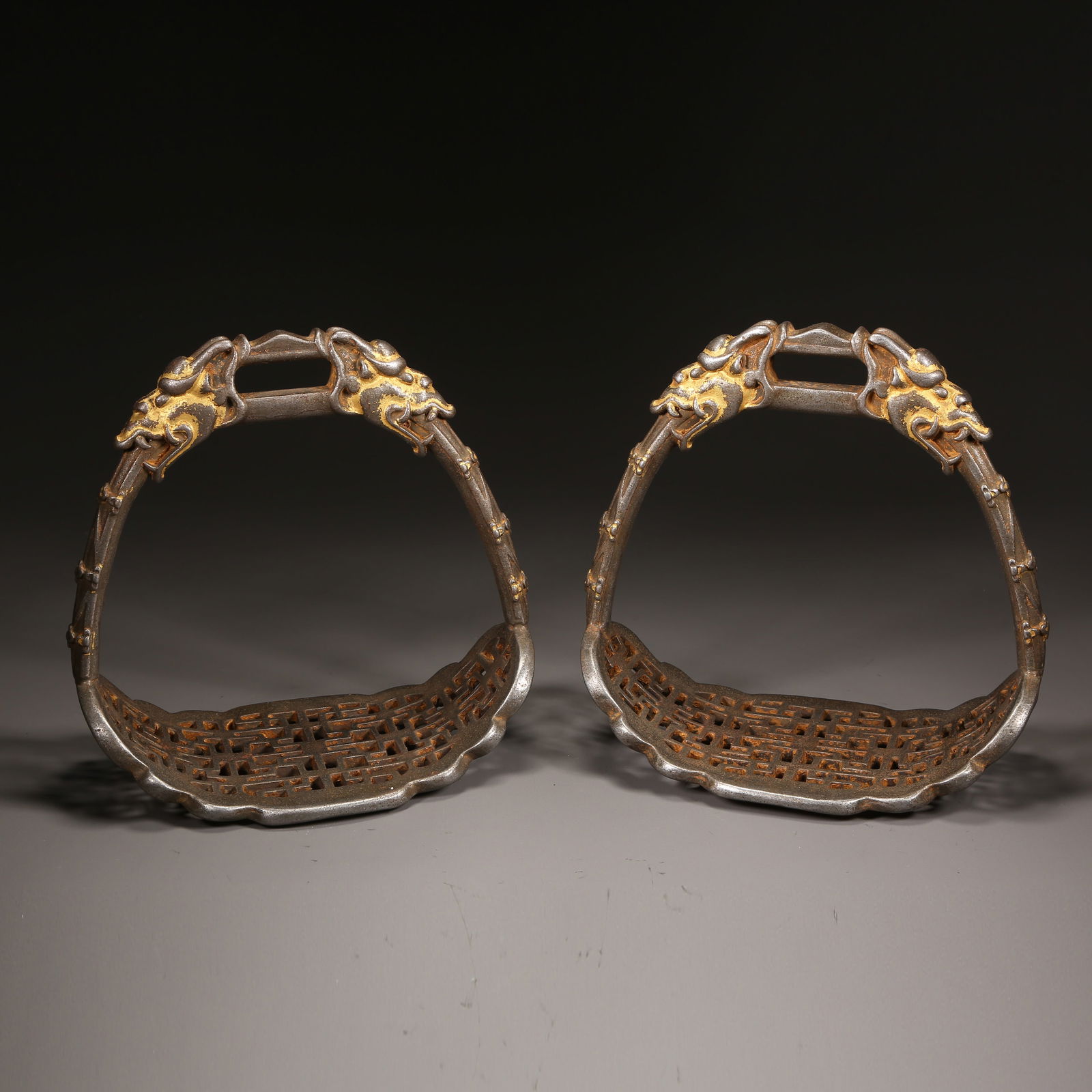 A QING DYNASTY PAIR OF IRON STIRRUPS WITH GILDED DRAGON DECORATION (1 of 11)
