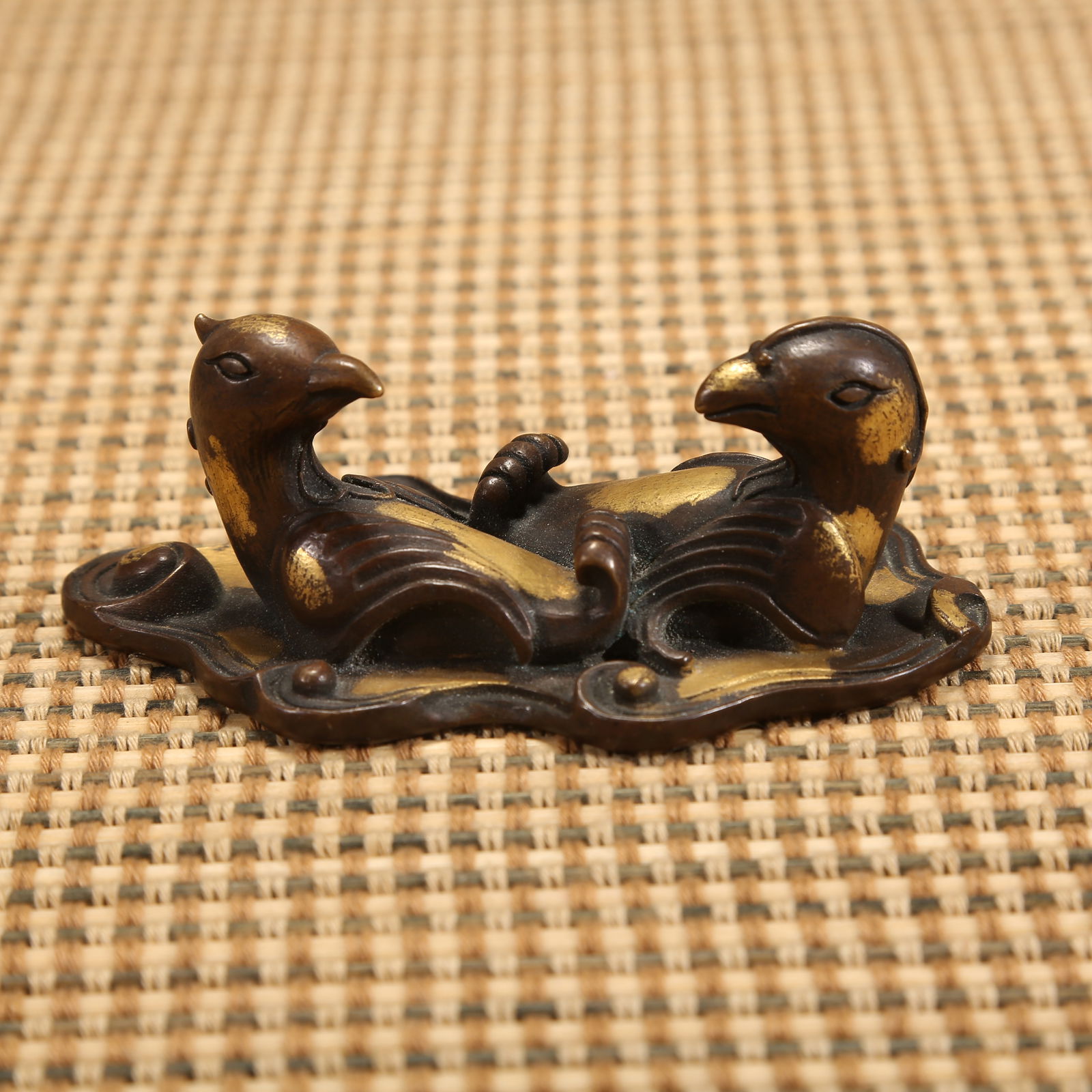 A MING DYNASTY PARTIALLY GILT-BRONZE MANDARIN DUCK PAPERWEIGHT: Ming dynasty partially gilt-bronze mandarin duck paperweight