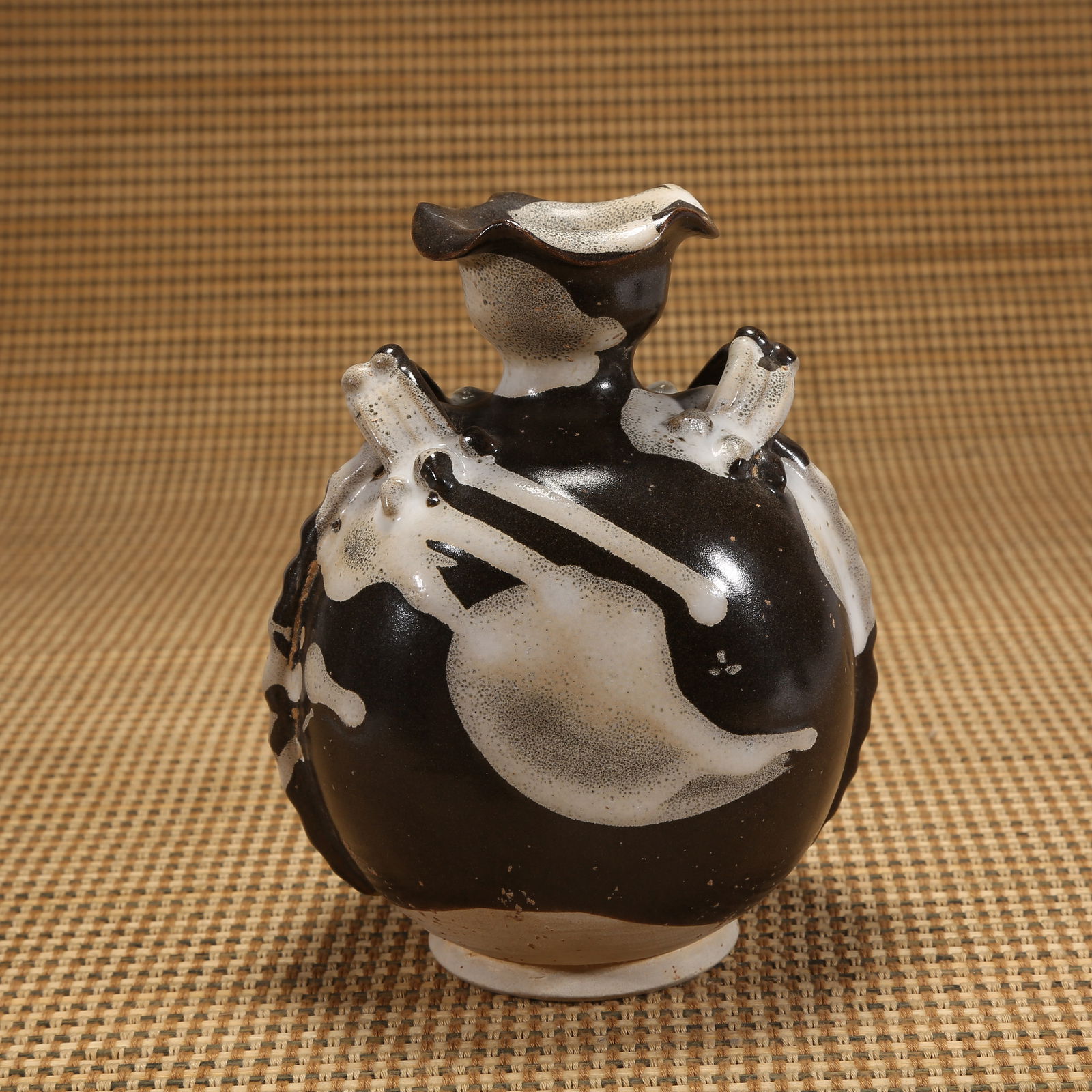 A TANG DYNASTY JUN KILN DOUBLE-HANDLED FLOWER-MOUTHED VASE: Tang dynasty Jun kiln double-handled flower-mouthed vase