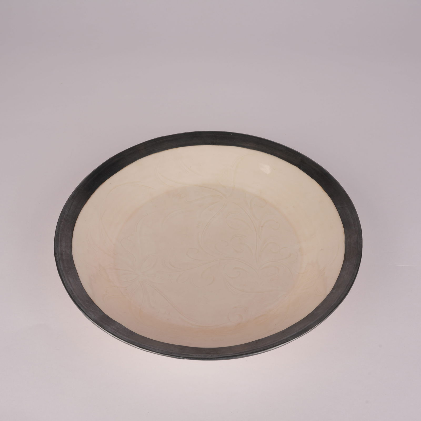 A DING KILN PLATE WITH SILVER RIM AND INCISED DESIGN, SONG DYNASTY (1 of 7)