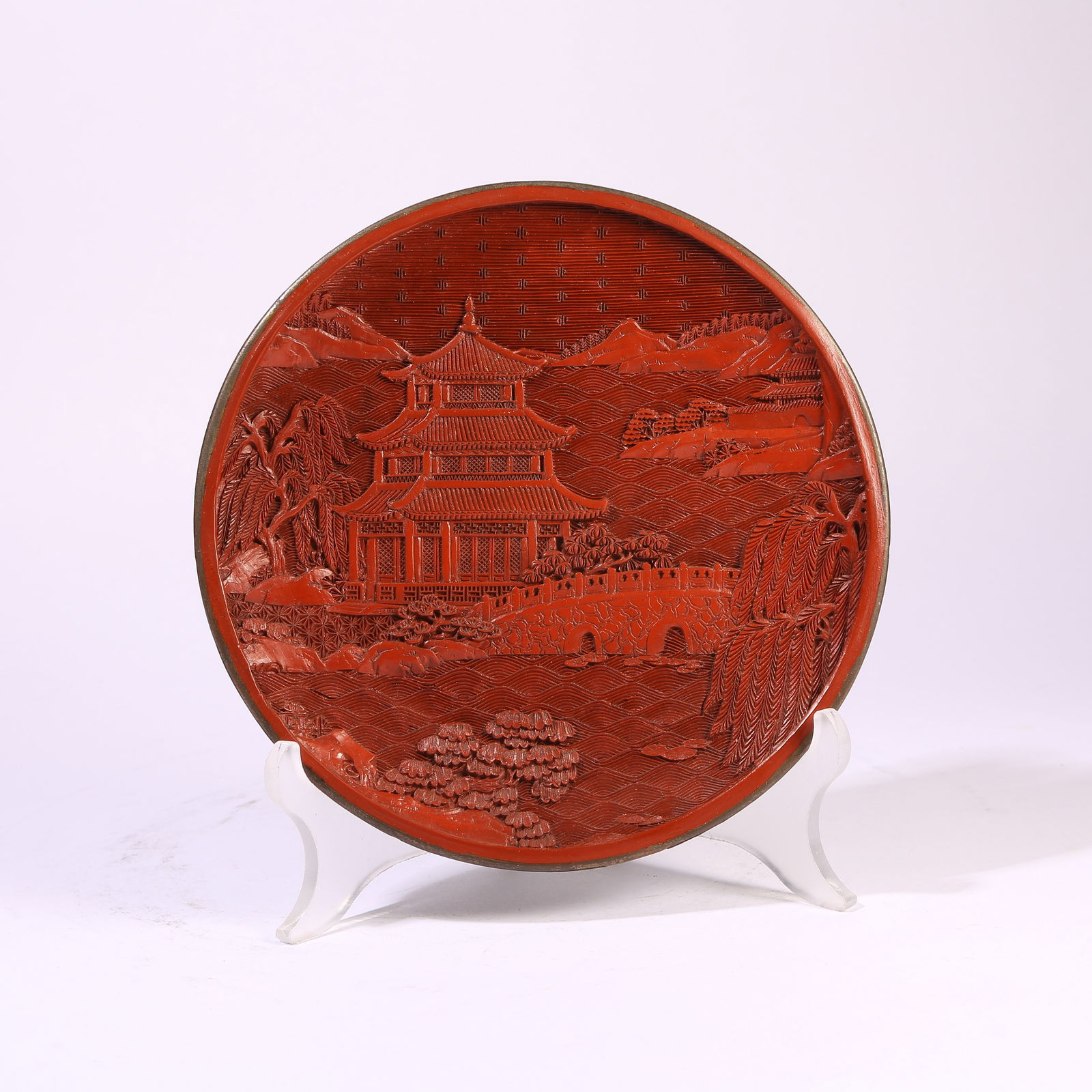 A CARVED RED LACQUER DISH WITH LANDSCAPE AND PAVILION MOTIFS: Carved Red Lacquer Dish with Landscape and Pavilion Motifs