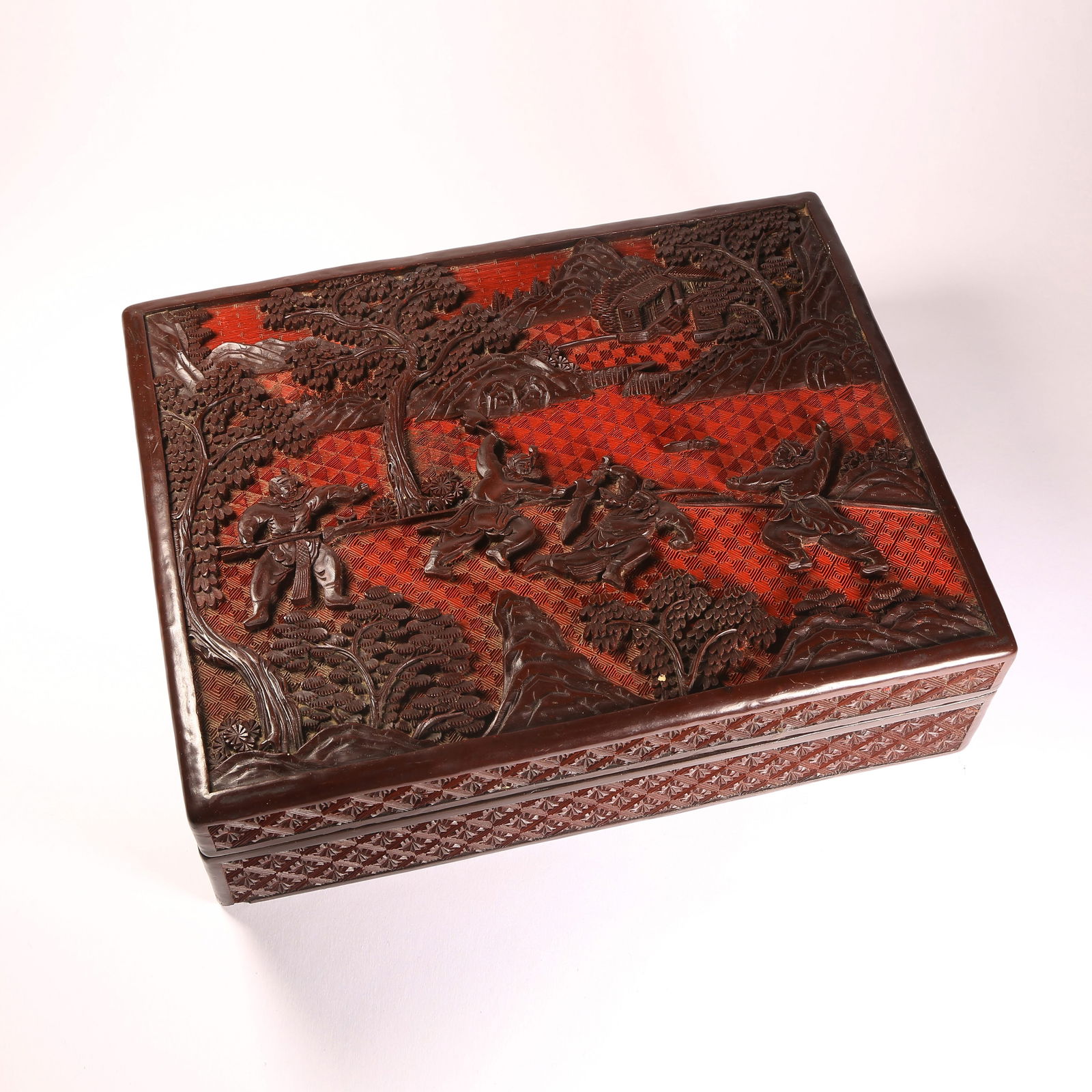 A CARVED LACQUER SQUARE COVERED BOX WITH FIGURE NARRATIVE AND DAOIST MOTIFS: Carved Lacquer Square Covered Box with Figure Narrative and Daoist Motifs