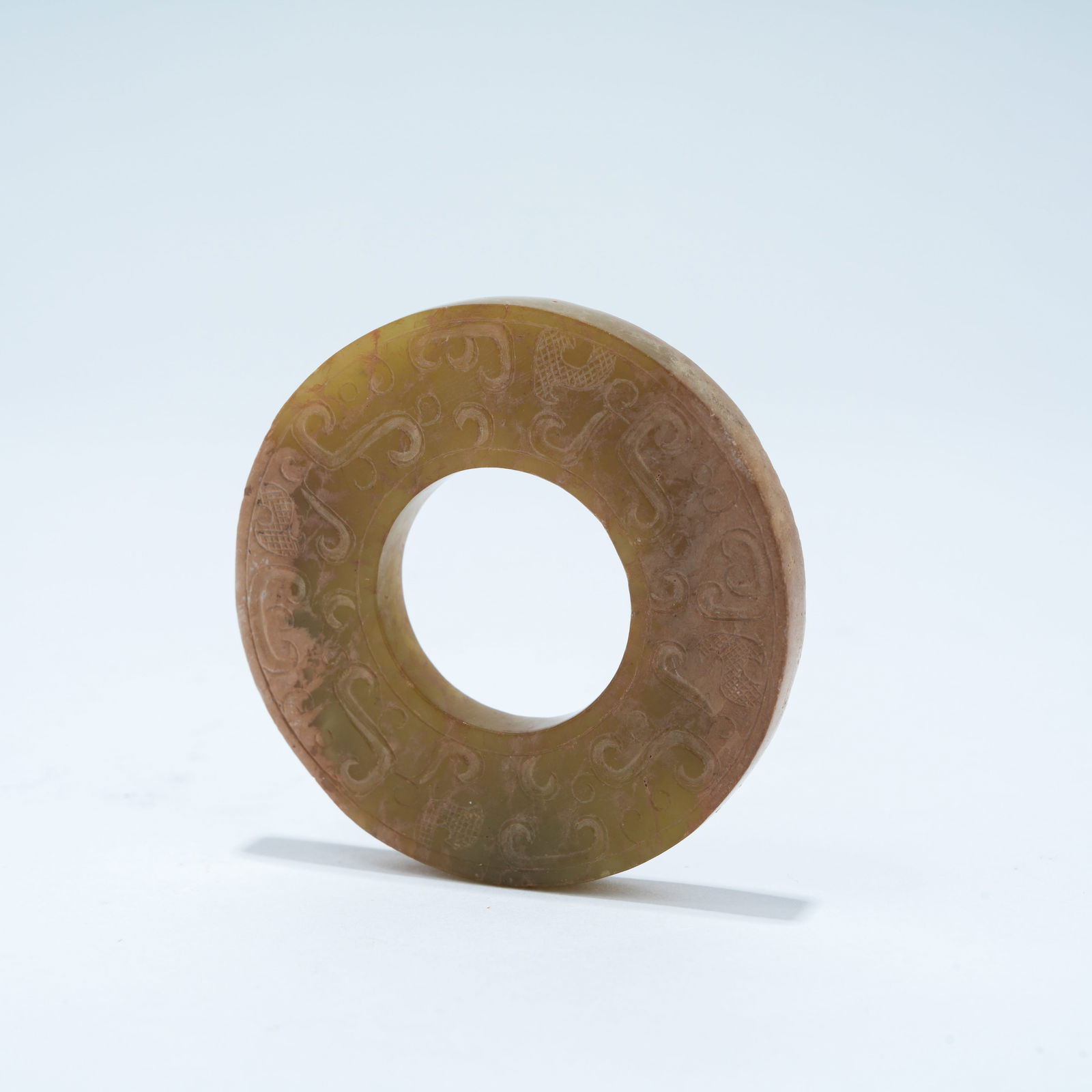 A ARCHAIC JADE CARVED BI DISC WITH LINKED-RING DESIGN: Archaic Jade Carved Bi Disc with Linked-Ring Design