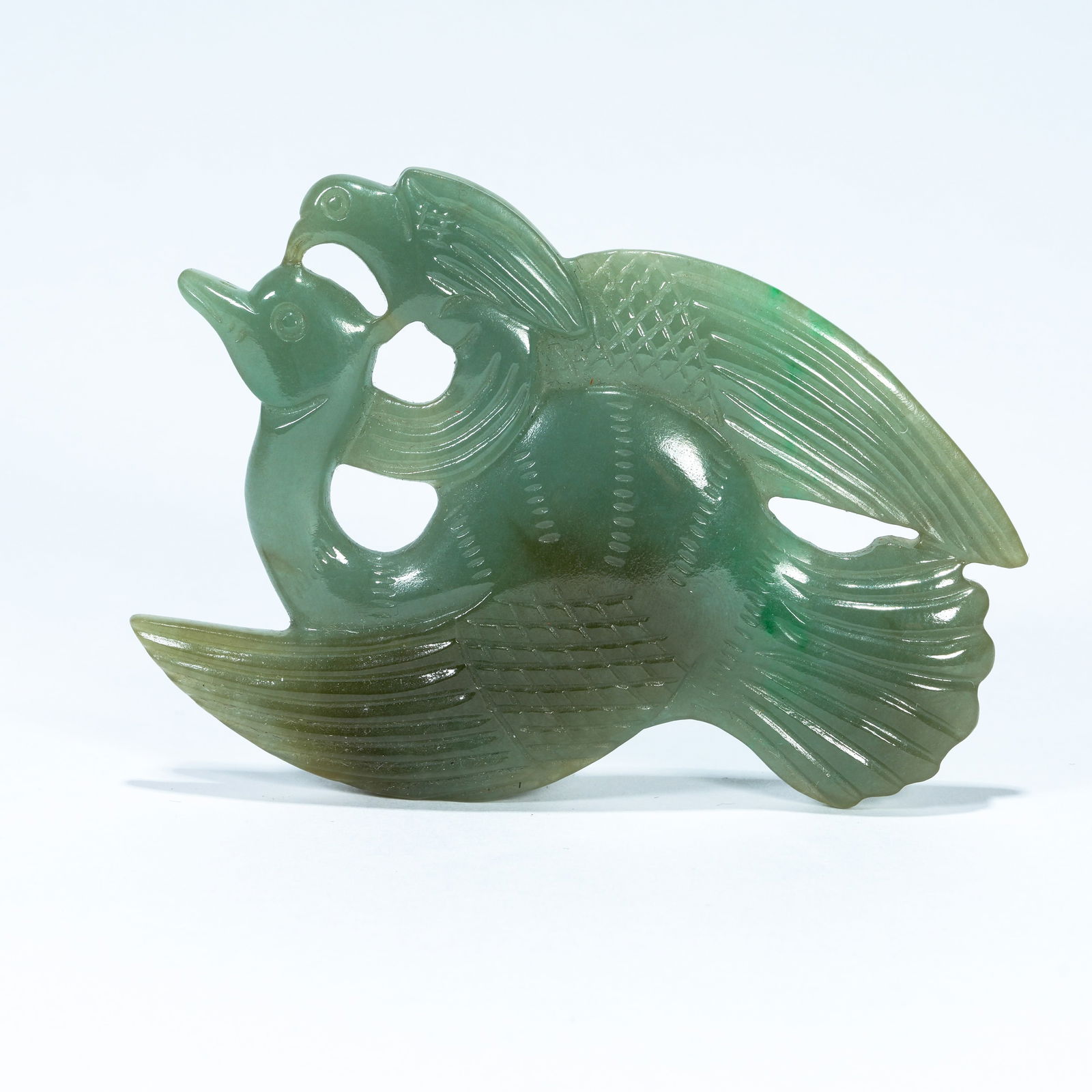 A JADEITE CARVED PENDANT OF A HAIDONGQING FALCON ATTACKING A WILD GOOSE (1 of 9)