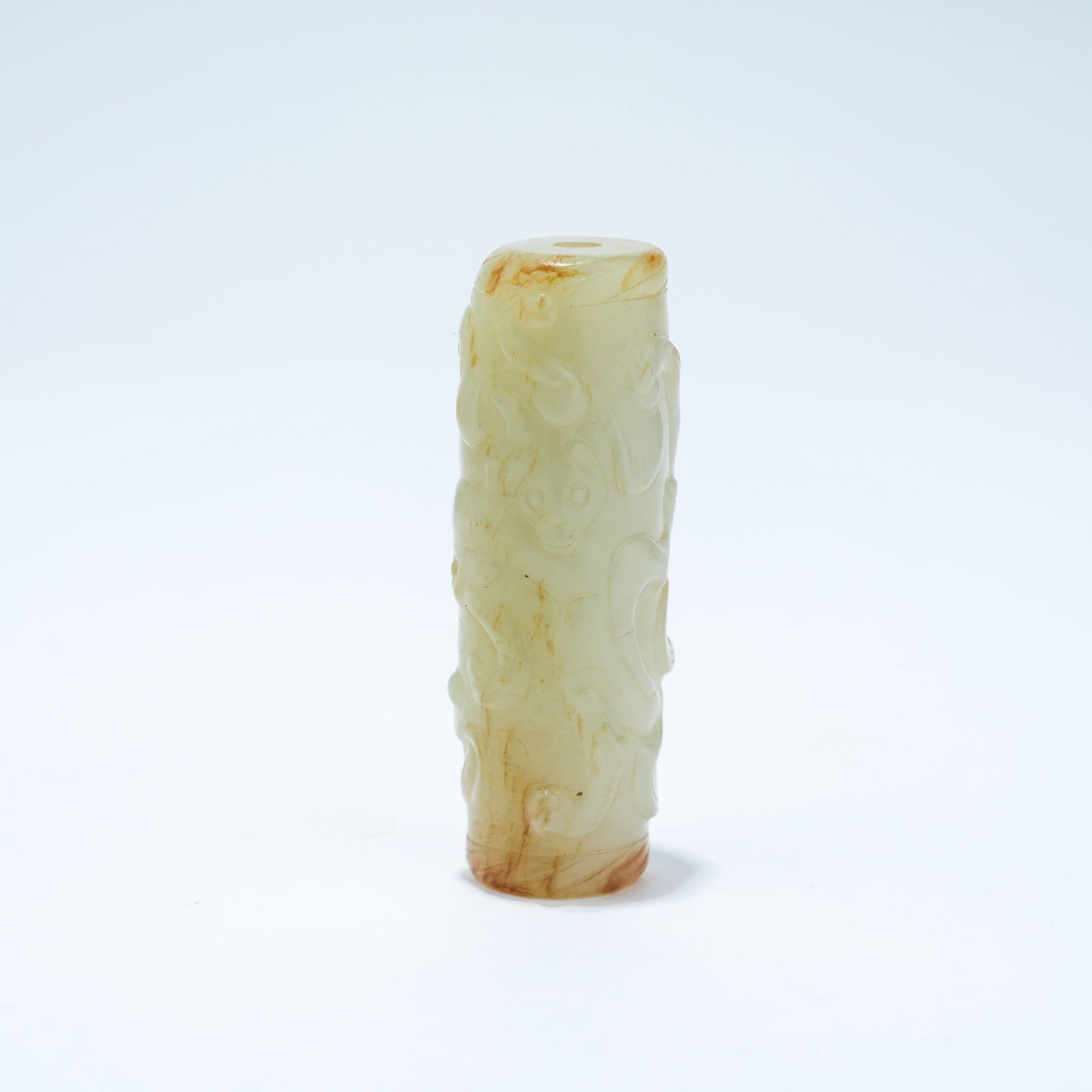 A HETIAN JADE CARVED BEAD WITH CHI-DRAGON DESIGN: Hetian Jade Carved Bead with Chi-Dragon Design