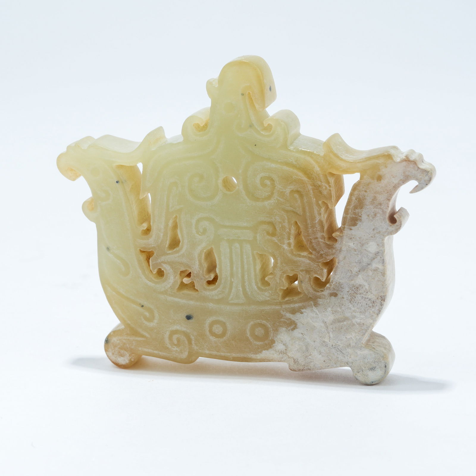 A HETIAN JADE CARVED PENDANT WITH BEAST MOTIF: Hetian Jade Carved Pendant with Beast Motif
