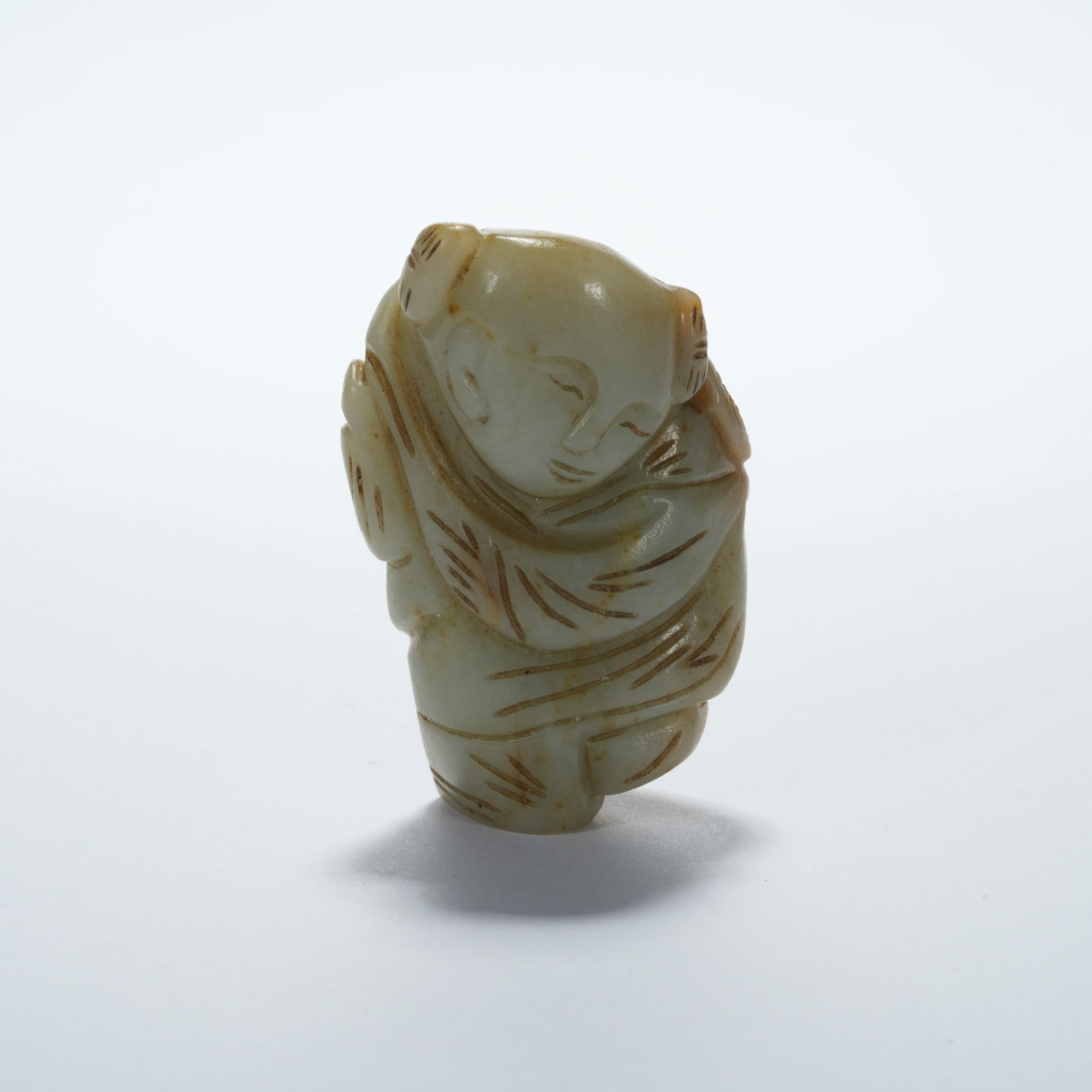 A HETIAN JADE CHILD-SHAPED PENDANT (1 of 10)