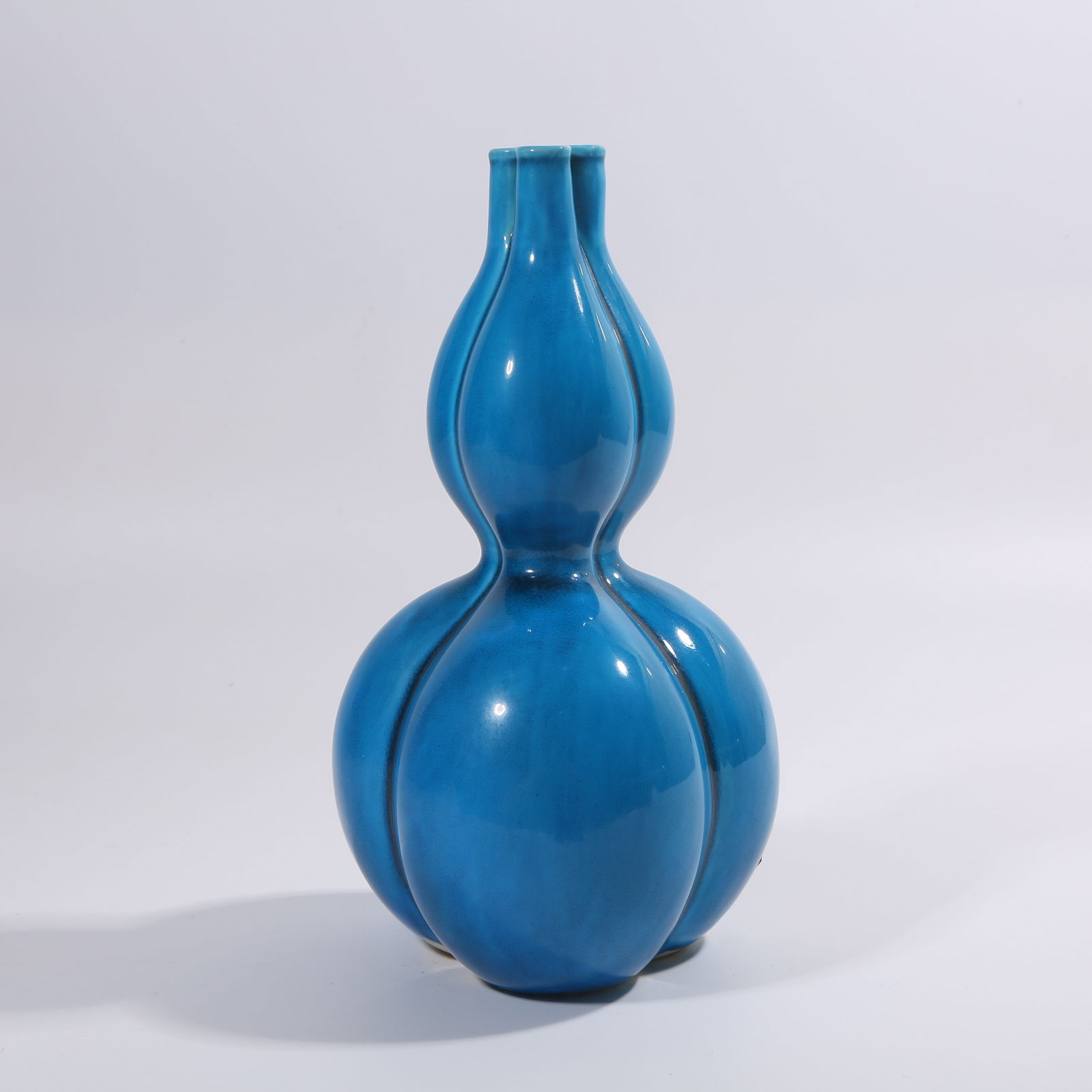 A QING DYNASTY PEACOCK-BLUE GLAZE THREE-HOLE GOURD VASE: Qing Dynasty Peacock-Blue Glaze Three-Hole Gourd Vase
