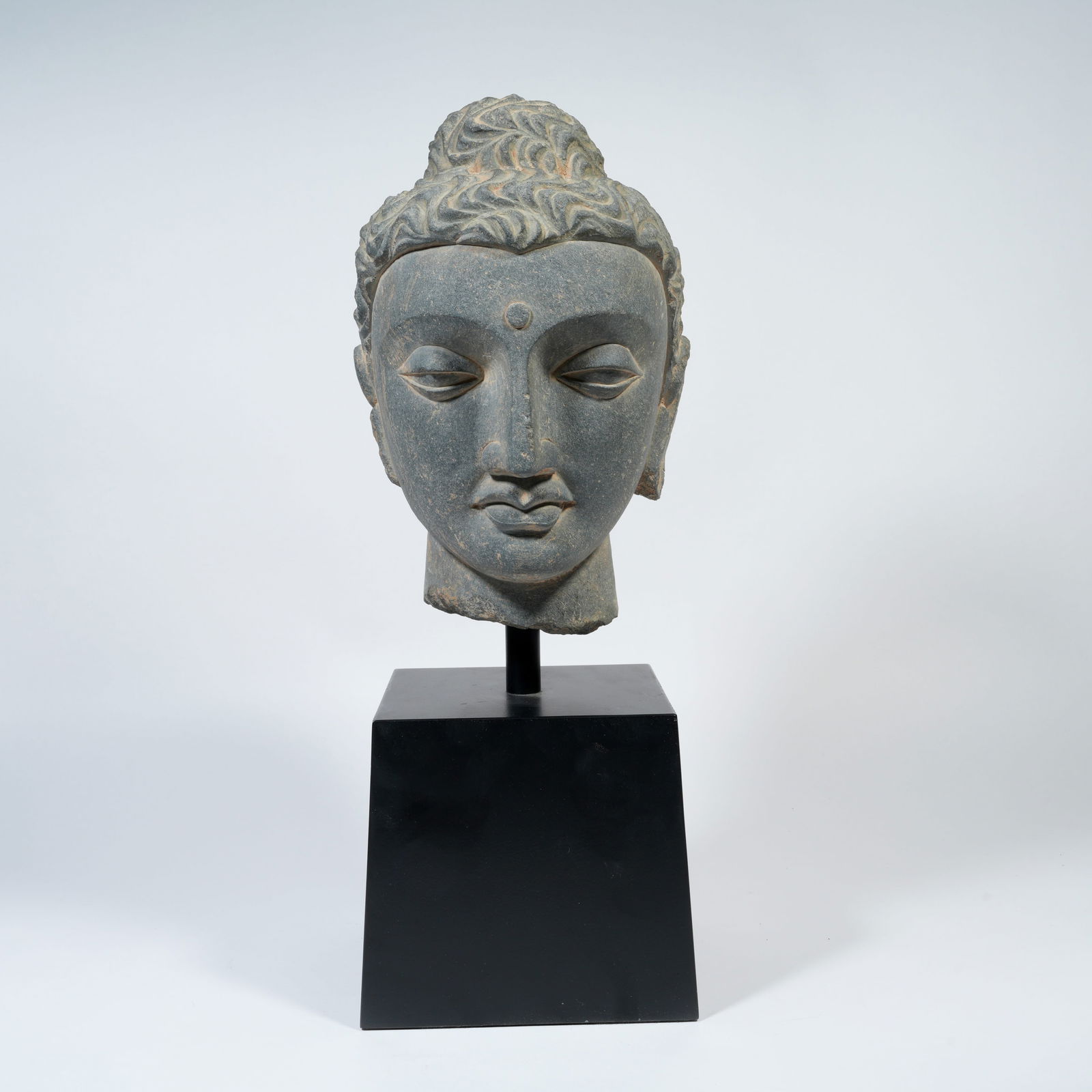 A STONE CARVED BUDDHIST HEAD (1 of 9)