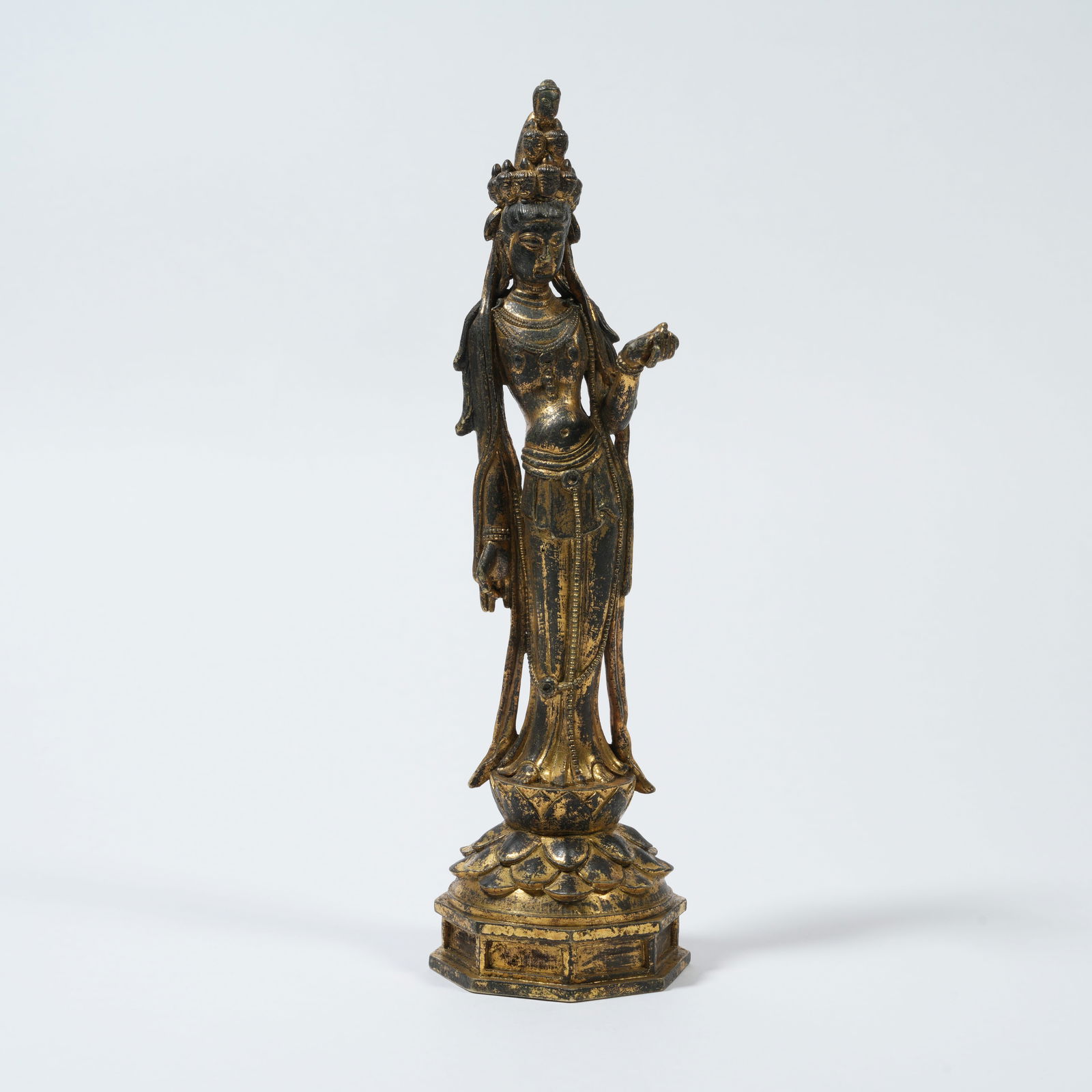 A GILT-BRONZE STANDING FIGURE OF ELEVEN-HEADED AVALOKITESHVARA: Gilt-Bronze Standing Figure of Eleven-Headed Avalokiteshvara