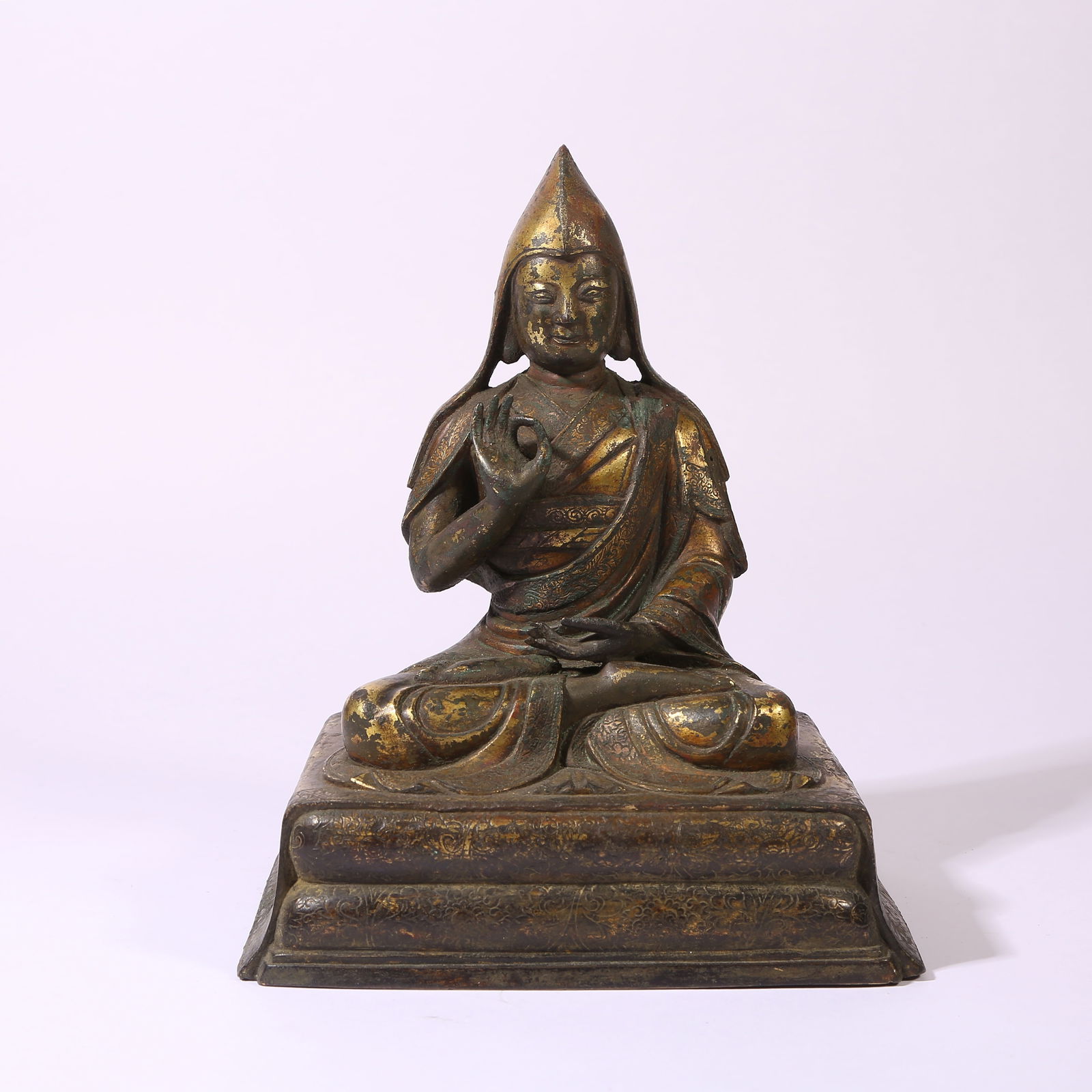 A GILT-BRONZE FIGURE OF A LAMA TEACHER (GURU): Gilt-Bronze Figure of a Lama Teacher (Guru)