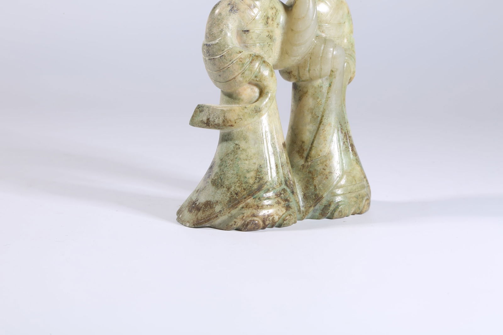 A ARCHAIC JADE DOUBLE-LINKED DANCING FIGURES - 8