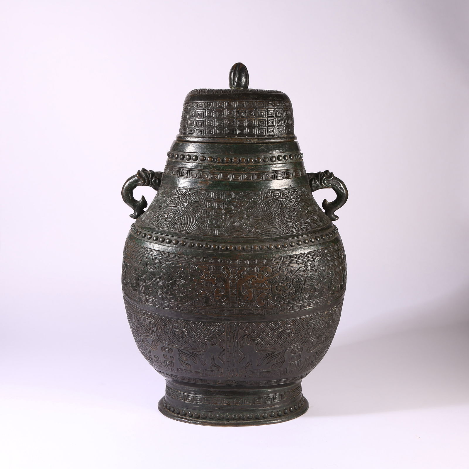 A BRONZE COVERED VASE WITH BEAST-HEAD HANDLES AND AUSPICIOUS BEAST MOTIFS: Bronze Covered Vase with Beast-Head Handles and Auspicious Beast Motifs