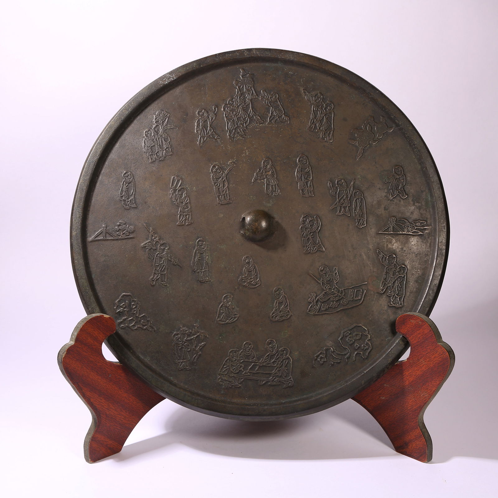 A BRONZE MIRROR WITH PLAYING CHILDREN MOTIF: Bronze Mirror with Playing Children Motif