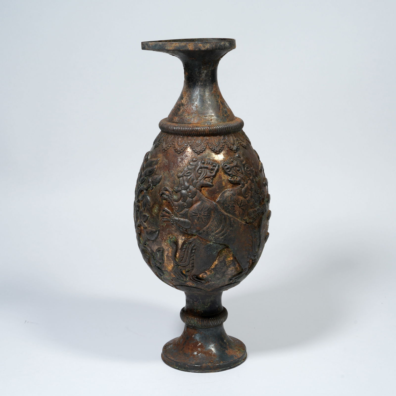 A SILVER EWER WITH AUSPICIOUS BEAST MOTIFS: Silver Ewer with Auspicious Beast Motifs