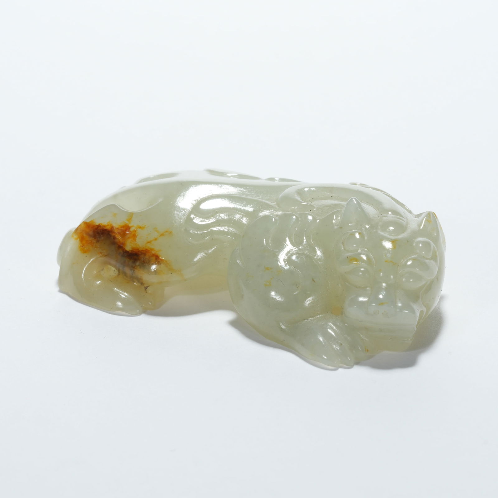 A HETIAN JADE CH’I-HU (MYTHICAL TIGER) FIGURINE: Hetian Jade Ch’i-hu (Mythical Tiger) Figurine