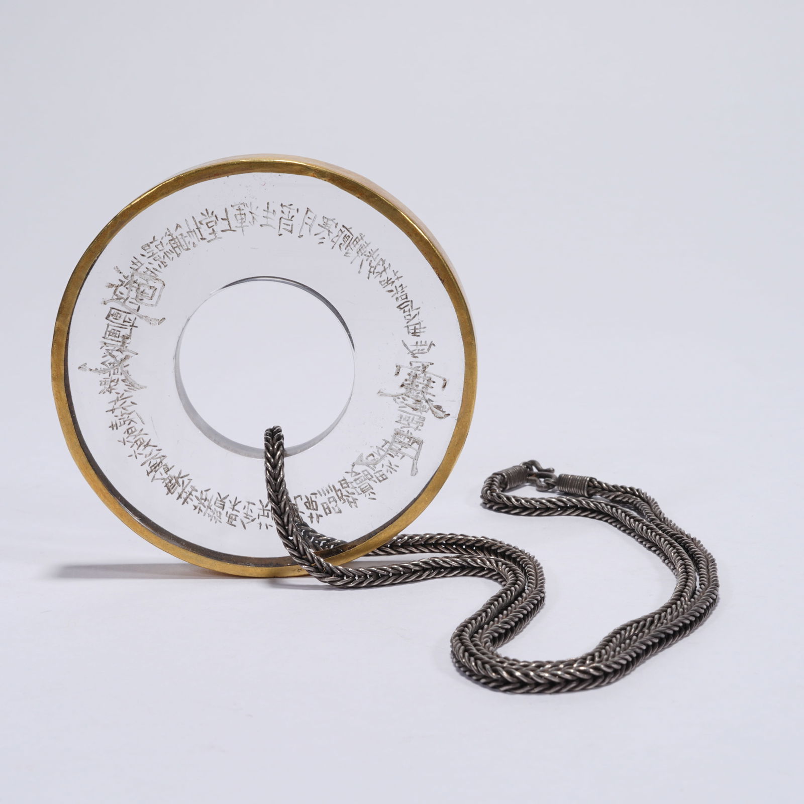 A ROCK CRYSTAL BI DISC MOUNTED WITH GILT: Rock Crystal Bi Disc Mounted with Gilt