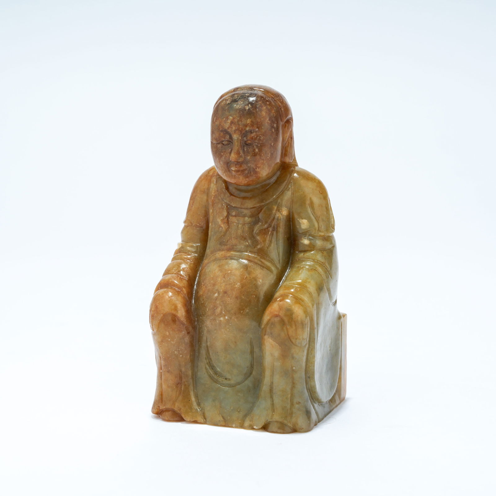 A HETIAN JADE CARVED SEATED FIGURE OF ZHENWU, THE PERFECTED WARRIOR: Hetian Jade Carved Seated Figure of Zhenwu, the Perfected Warrior