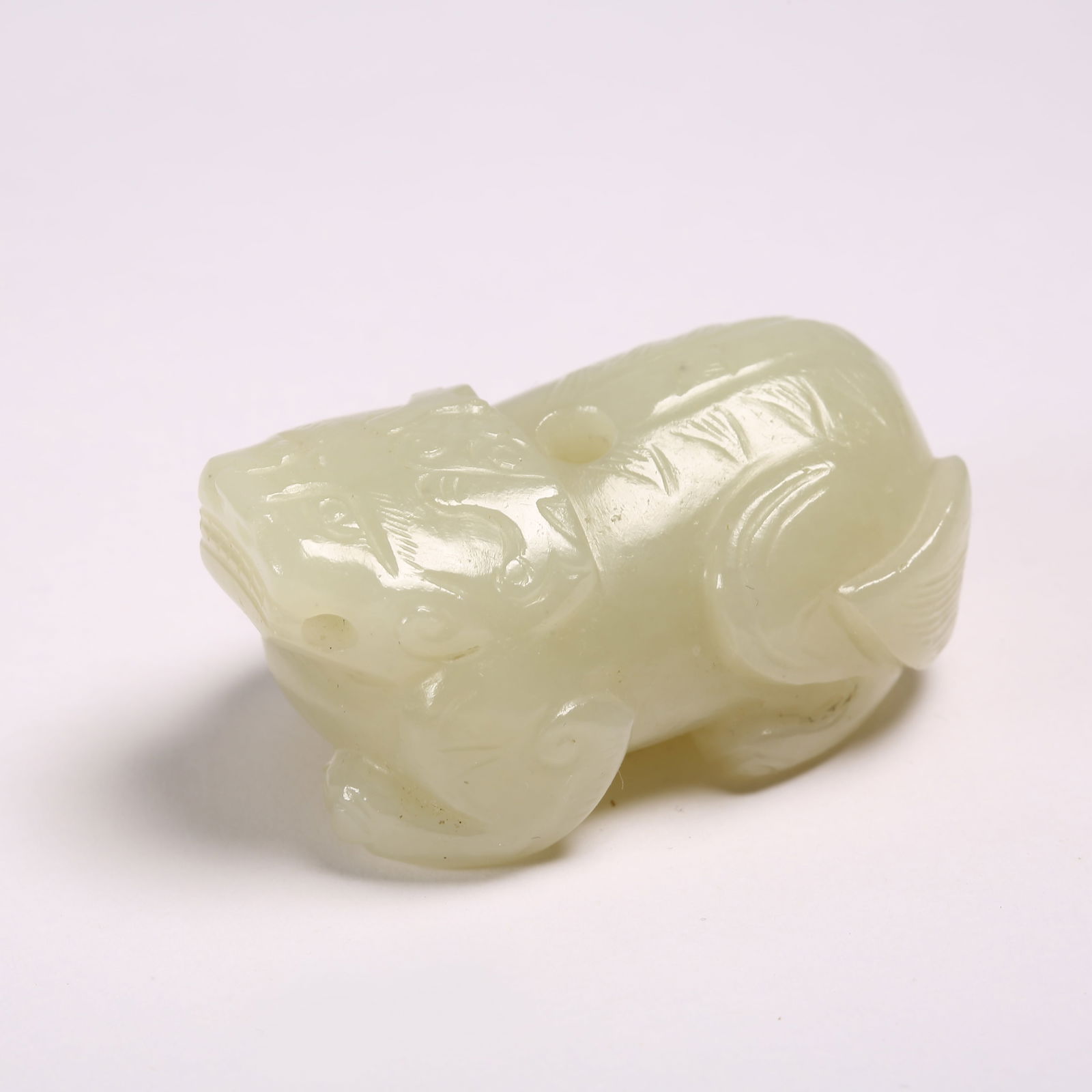 A HETIAN JADE AUSPICIOUS BEAST FIGURINE: Hetian Jade Auspicious Beast Figurine