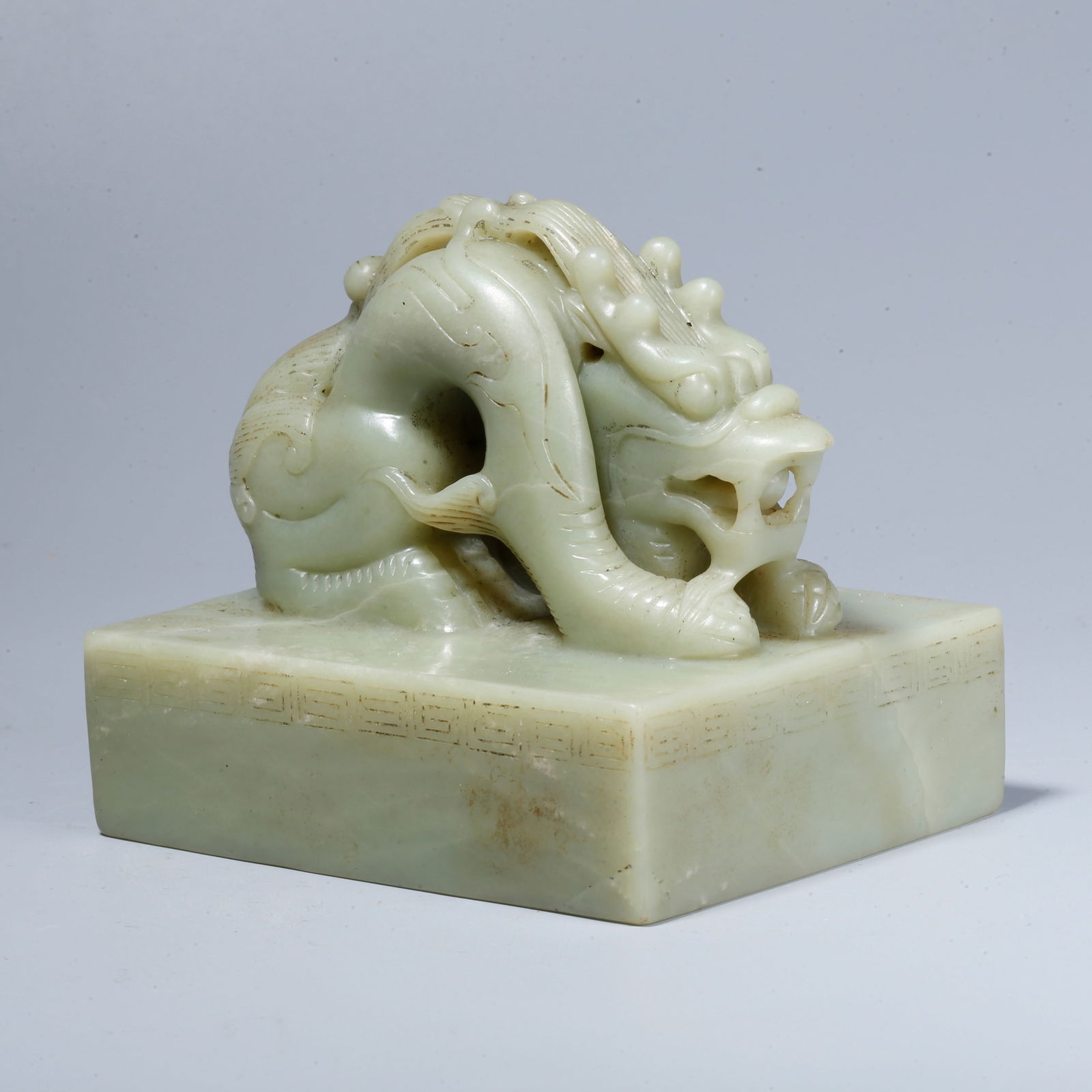 A HETIAN JADE SEAL WITH RECLINING DRAGON KNOB: Hetian Jade Seal with Reclining Dragon Knob