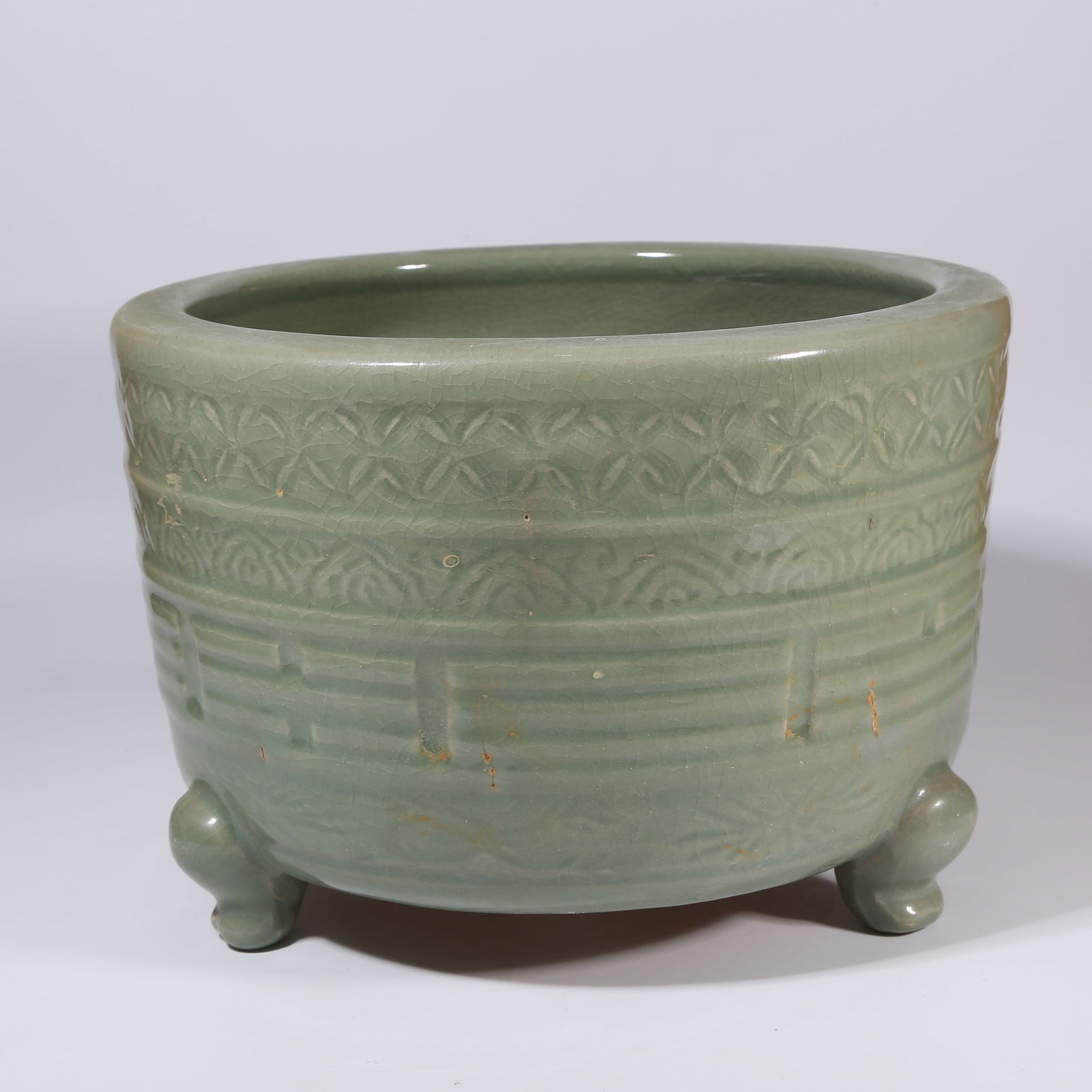 A LONGQUAN KILN TRIPOD CYLINDRICAL CENSER WITH BAGUA MOTIFS: Longquan Kiln Tripod Cylindrical Censer with Bagua Motifs