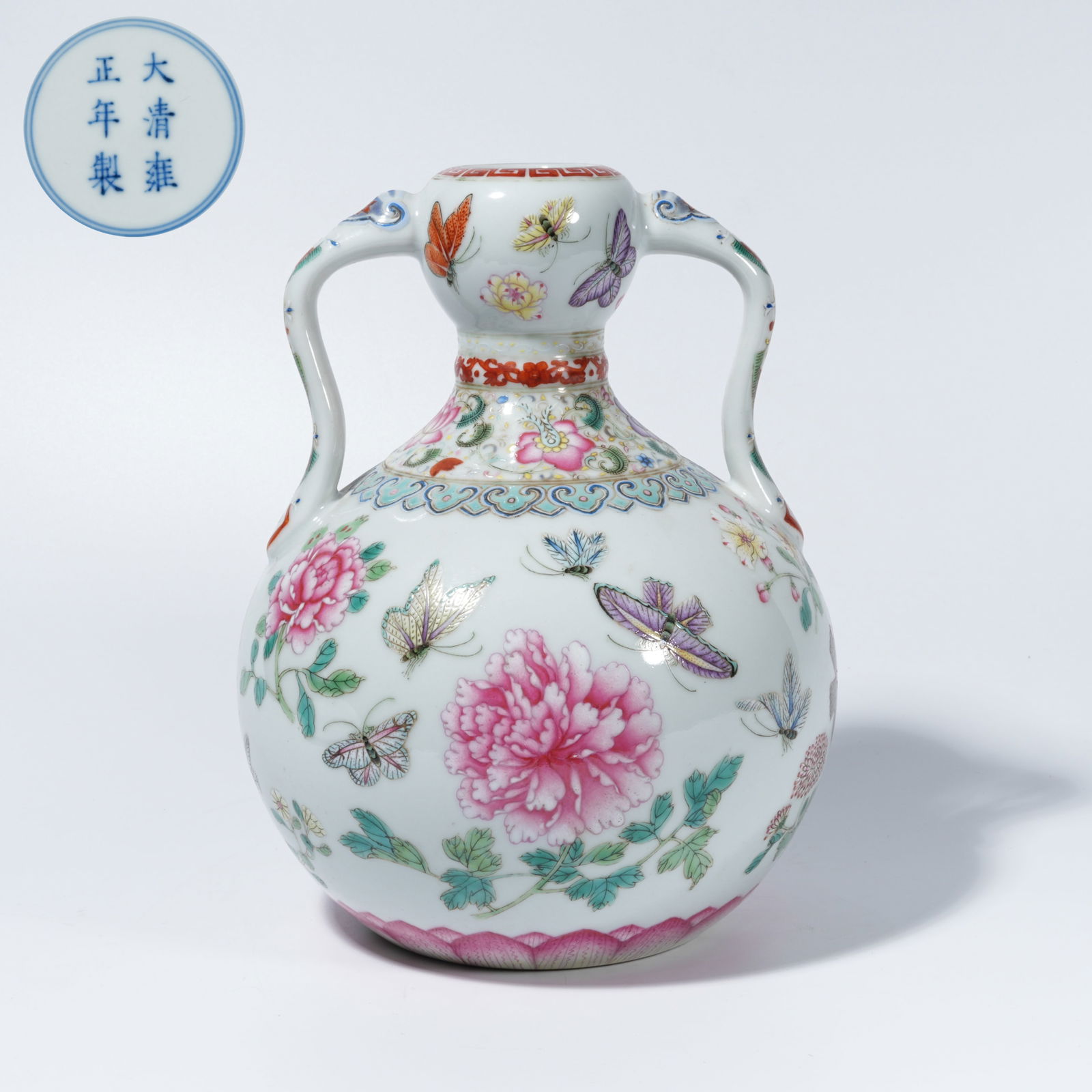 A FAMILLE-ROSE DOUBLE-ELEPHANT-HANDLED VASE WITH FLOWER-AND-BUTTERFLY MOTIF: Famille-Rose Double-Elephant-Handled Vase with Flower-and-Butterfly Motif