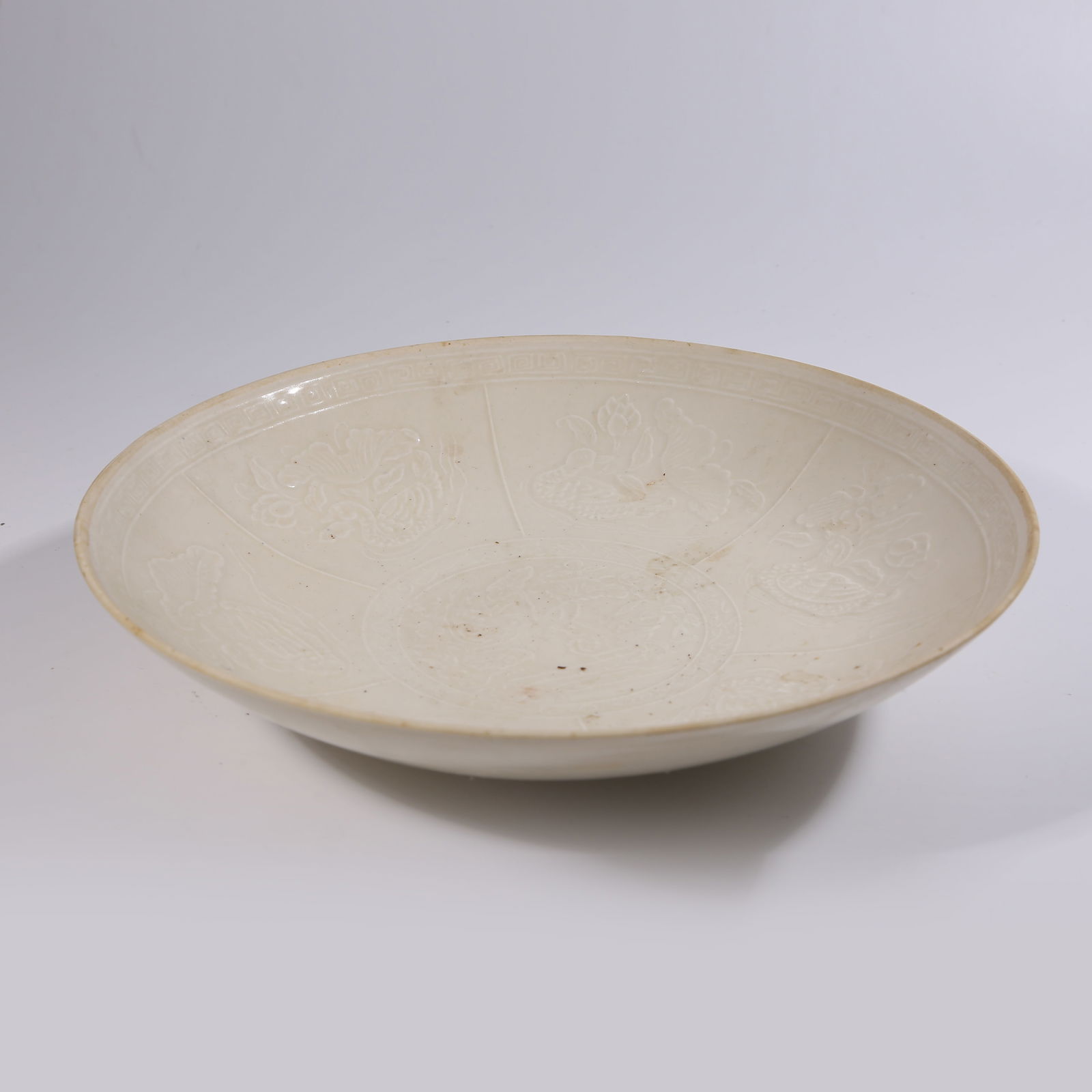 A DING WARE PLATE WITH INCISED LOTUS POND AND MANDARIN DUCK PATTERN: Ding Ware Plate with Incised Lotus Pond and Mandarin Duck Pattern
