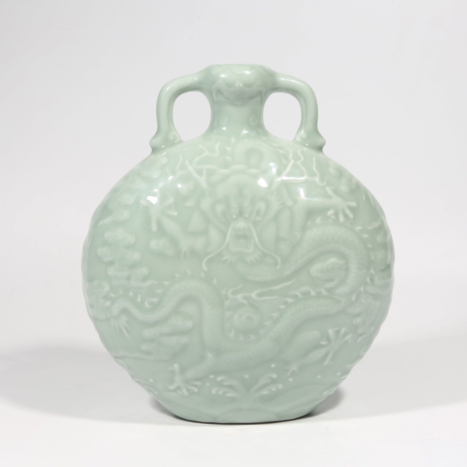 A POWDER BLUE GLAZE CLOUD DRAGON PATTERN FLAT VASE: Powder blue glaze cloud dragon pattern flat vase