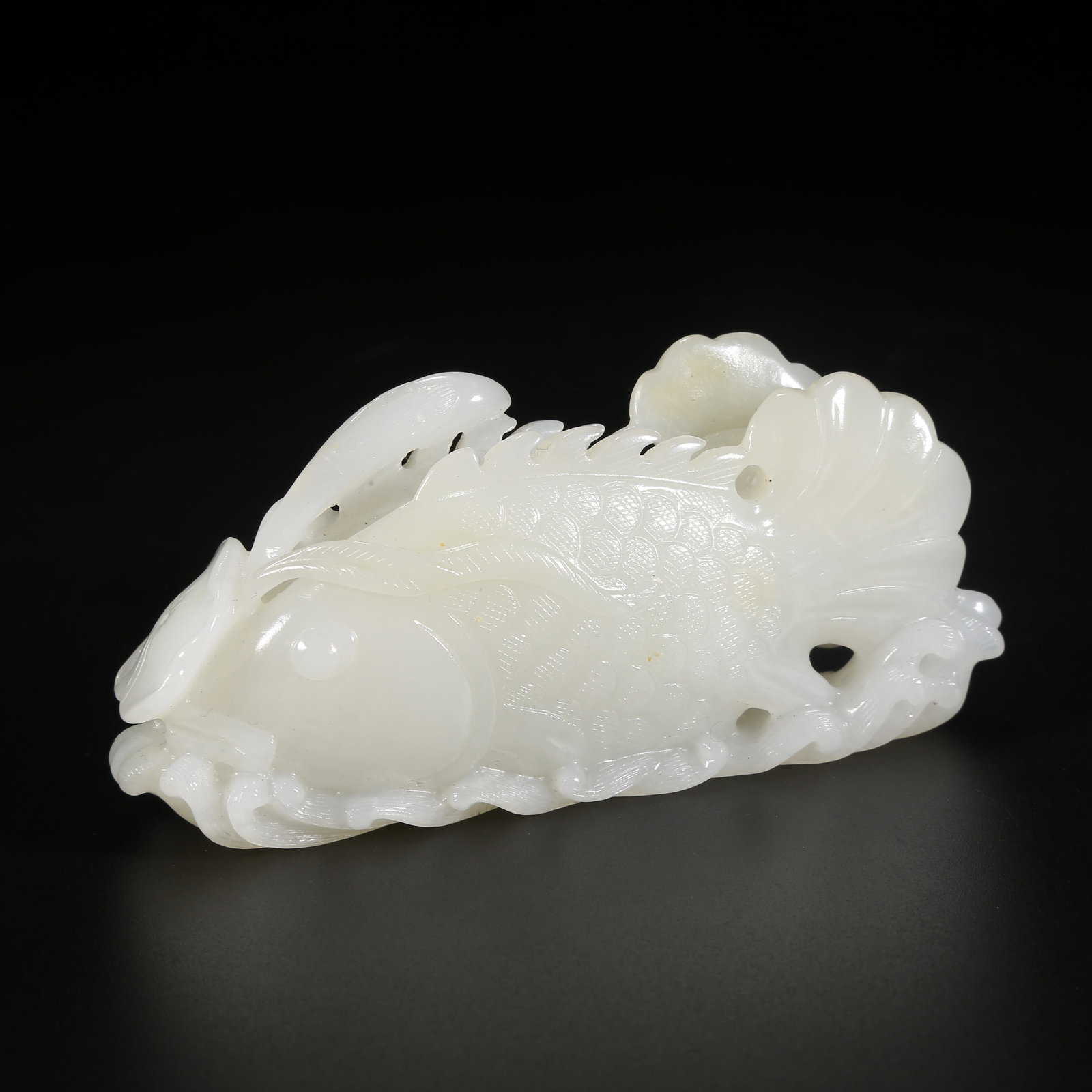 A HETIAN WHITE JADE YEAR OF SURPLUS ORNAMENT: Hetian White Jade Year of Surplus Ornament