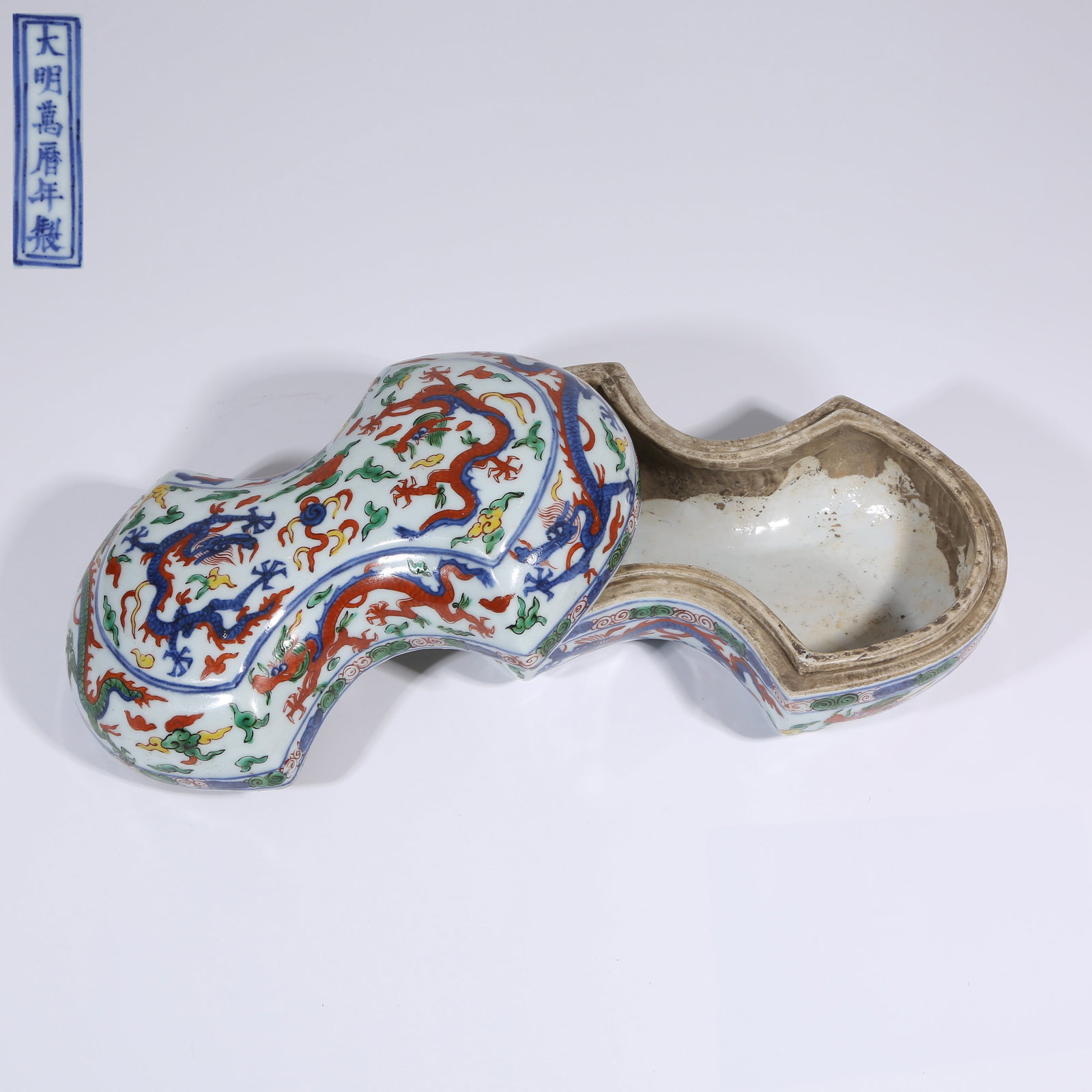 A FAMILLE ROSE CLOUD AND DRAGON "PEARL-CHASING" SILVER INGOT-SHAPED COVERED BOX: Famille Rose Cloud and Dragon "Pearl-Chasing" Silver Ingot-Shaped Covered Box