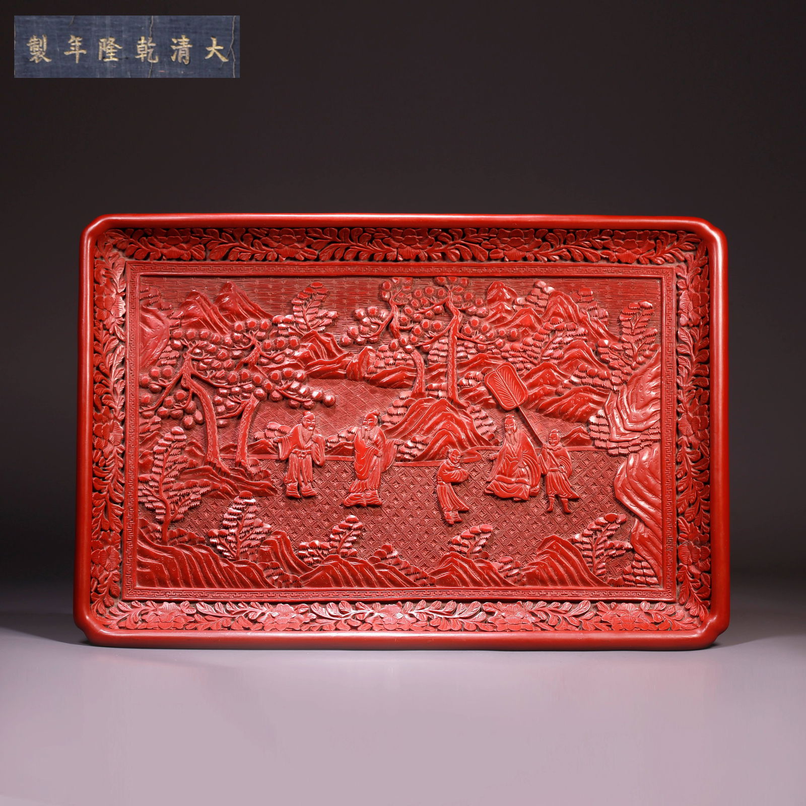 A CARVED RED LACQUER PLATE WITH FIGURATIVE STORY DESIGN: Carved Red Lacquer Plate with Figurative Story Design