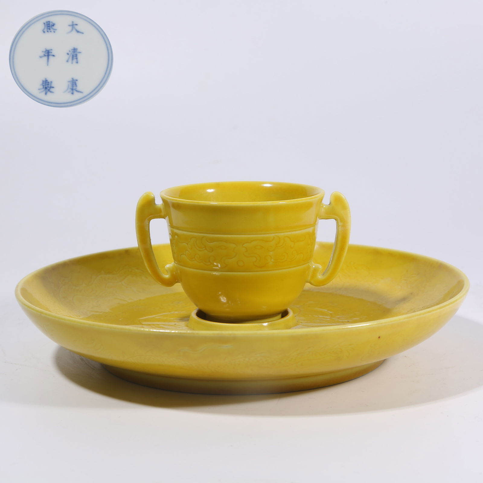 A YELLOW GLAZE WITH INCISED CLOUD AND DRAGON CHASING PEARL DOUBLE-HANDLED CUP STAND: Yellow Glaze with Incised Cloud and Dragon Chasing Pearl Double-Handled Cup Stand