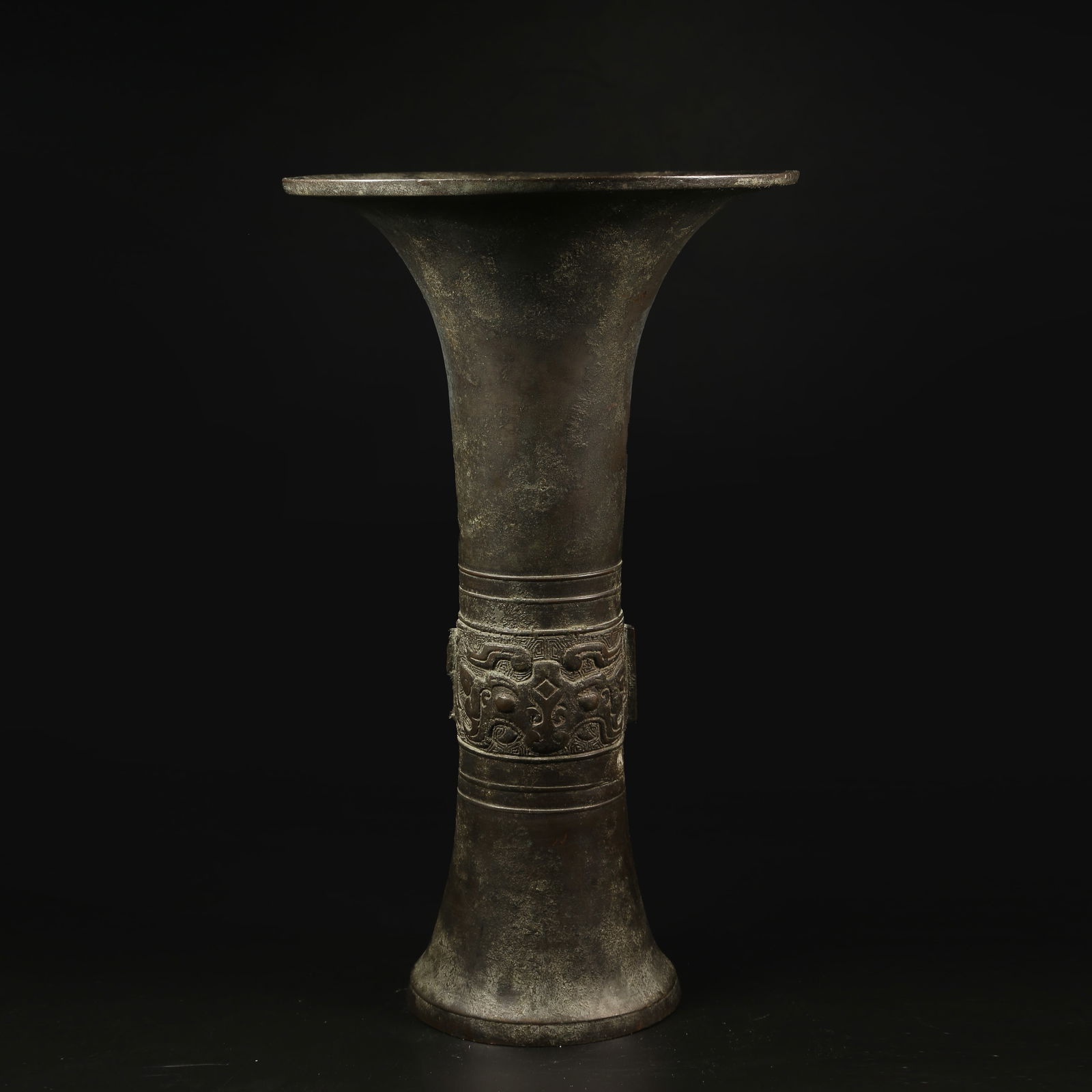 A BRONZE TRIPOD HU WITH TAOTIE MASK DESIGN: Bronze Tripod Hu with Taotie Mask Design