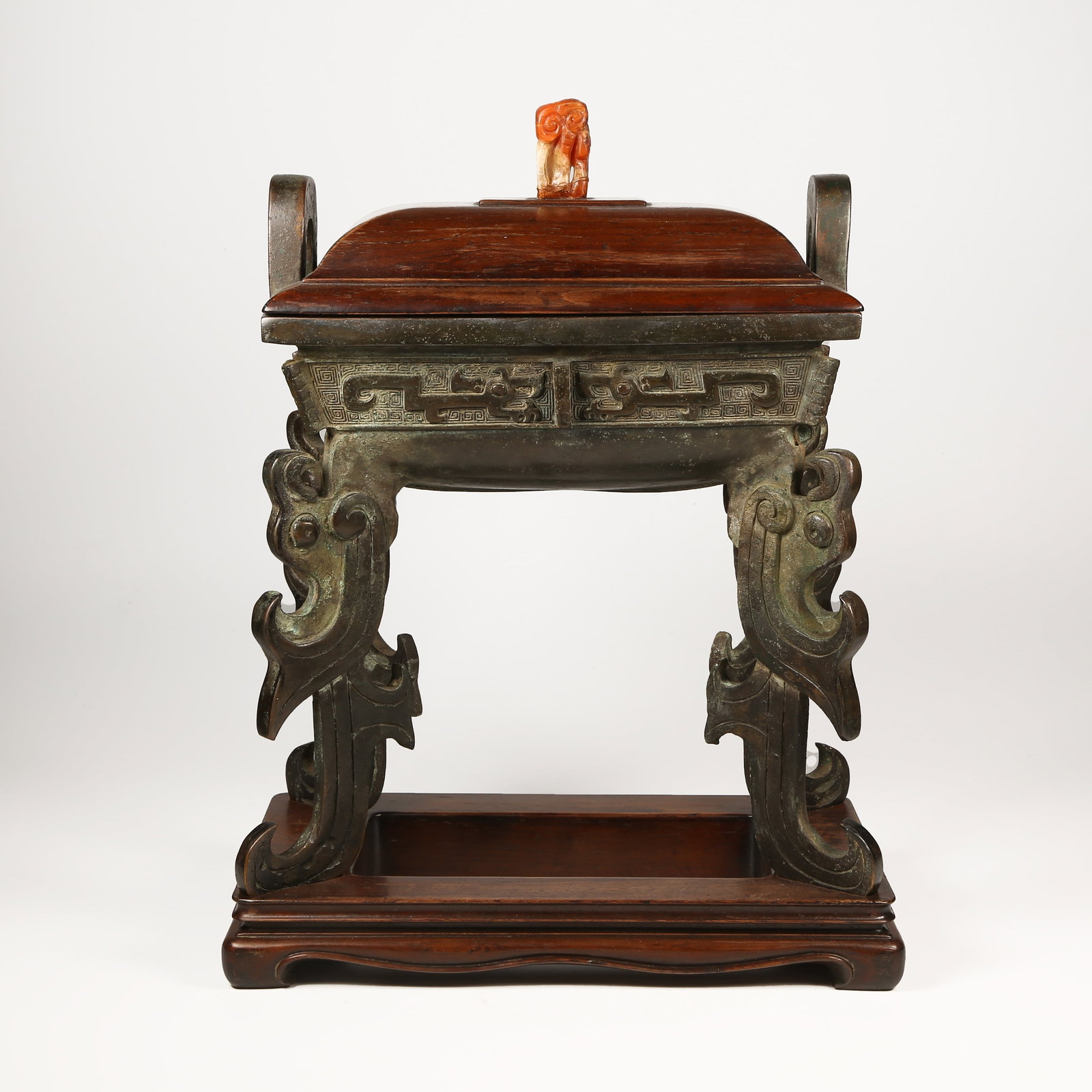 A BRONZE DING-SHAPED CENSER WITH FOUR PHOENIX FEET AND UPRIGHT FINIALS: Bronze Ding-Shaped Censer with Four Phoenix Feet and Upright Finials