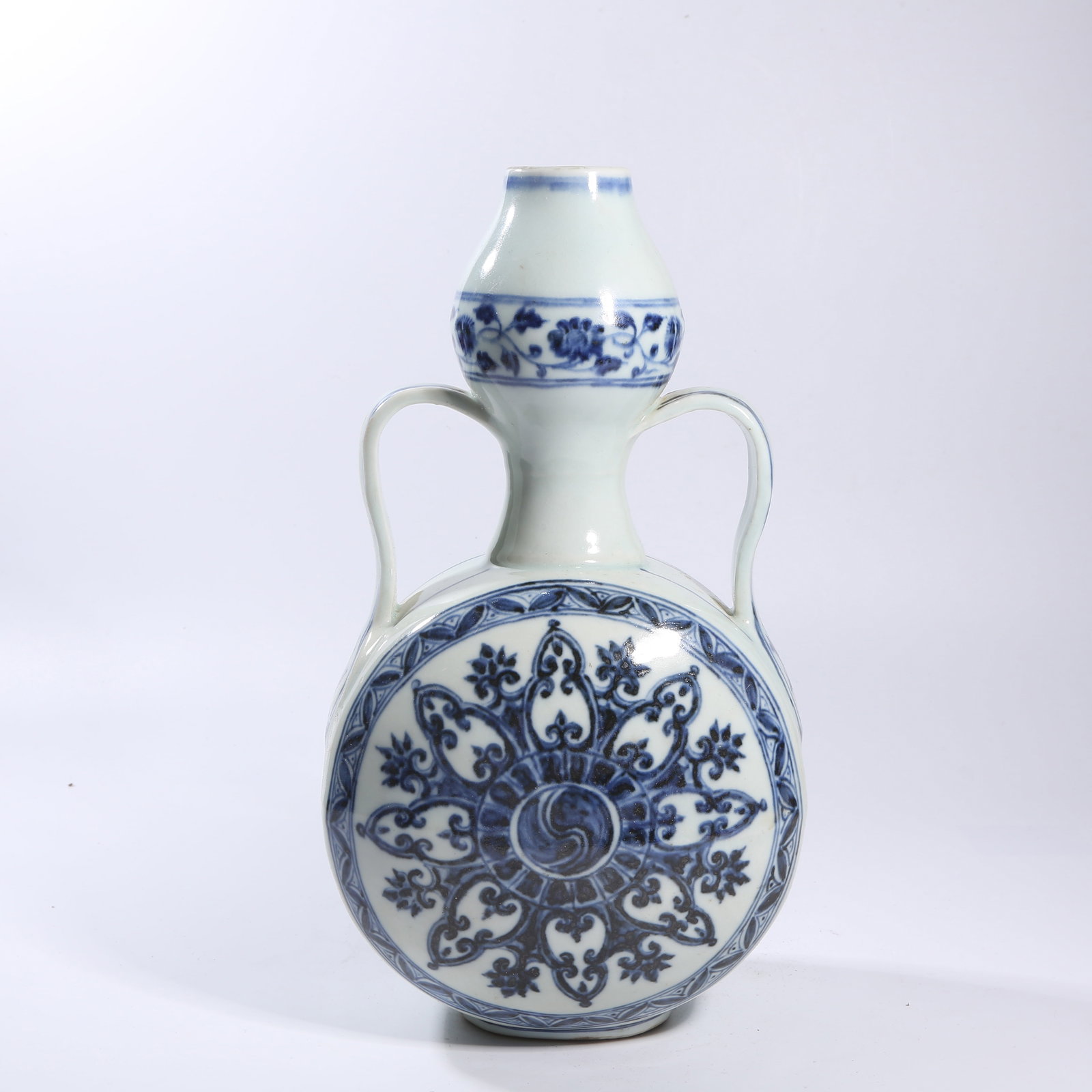 A BLUE-AND-WHITE TREASURE-FLOWER PATTERNED RIBBON-HANDLED MOON FLASK: Blue-and-white treasure-flower patterned ribbon-handled moon flask