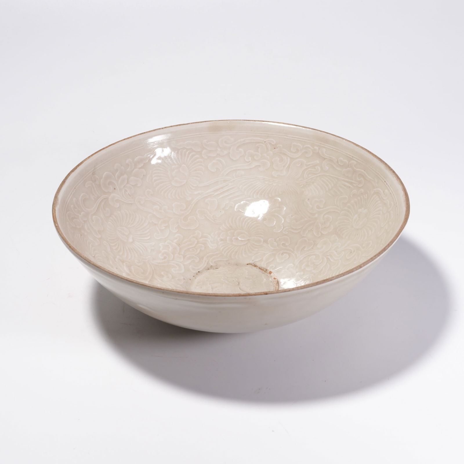 A DING KILN BOWL WITH INTERTWINED FLORAL PATTERN: Ding Kiln Bowl with Intertwined Floral Pattern