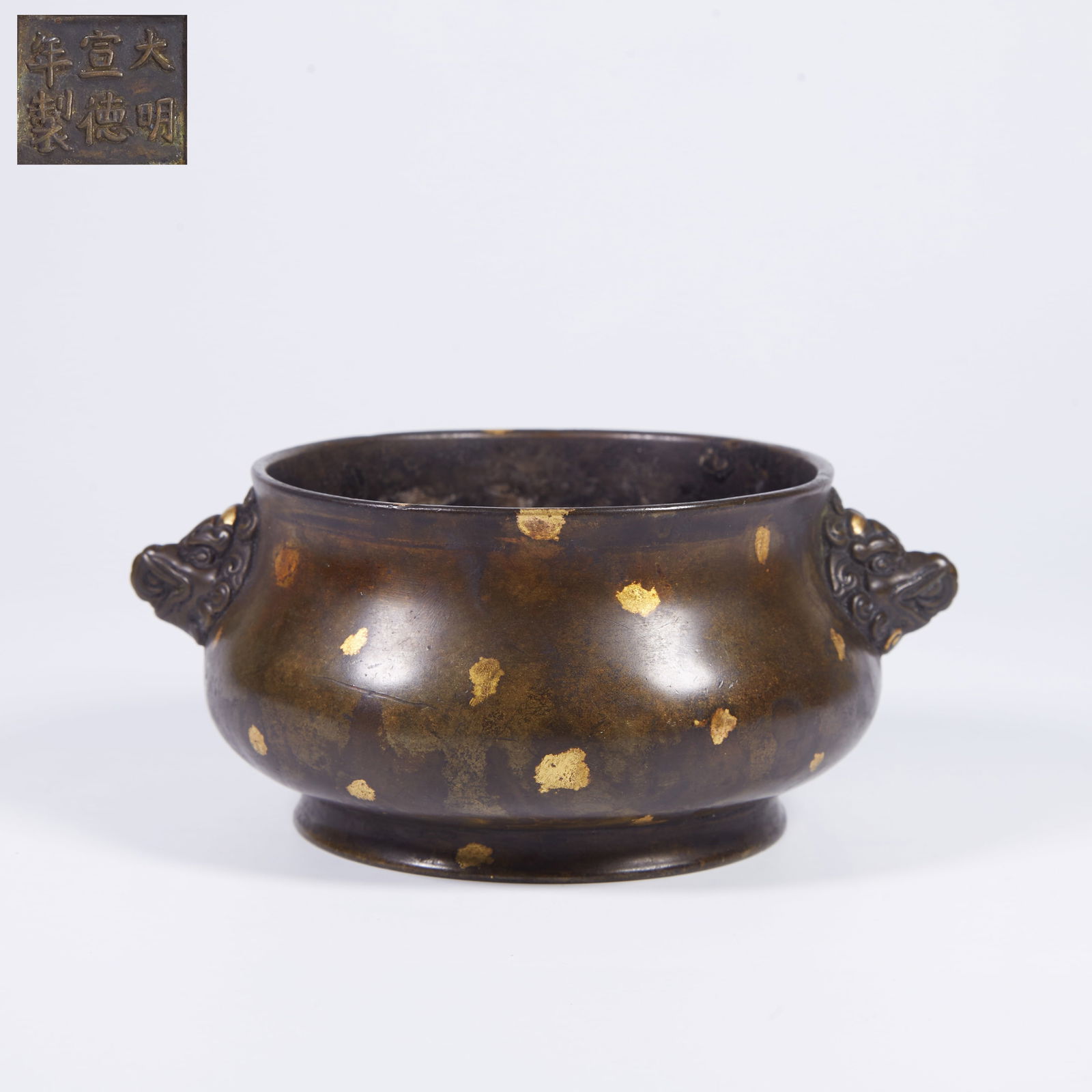 A BRONZE INCENSE BURNER WITH BEAST-MASK HANDLES: Bronze incense burner with beast-mask handles