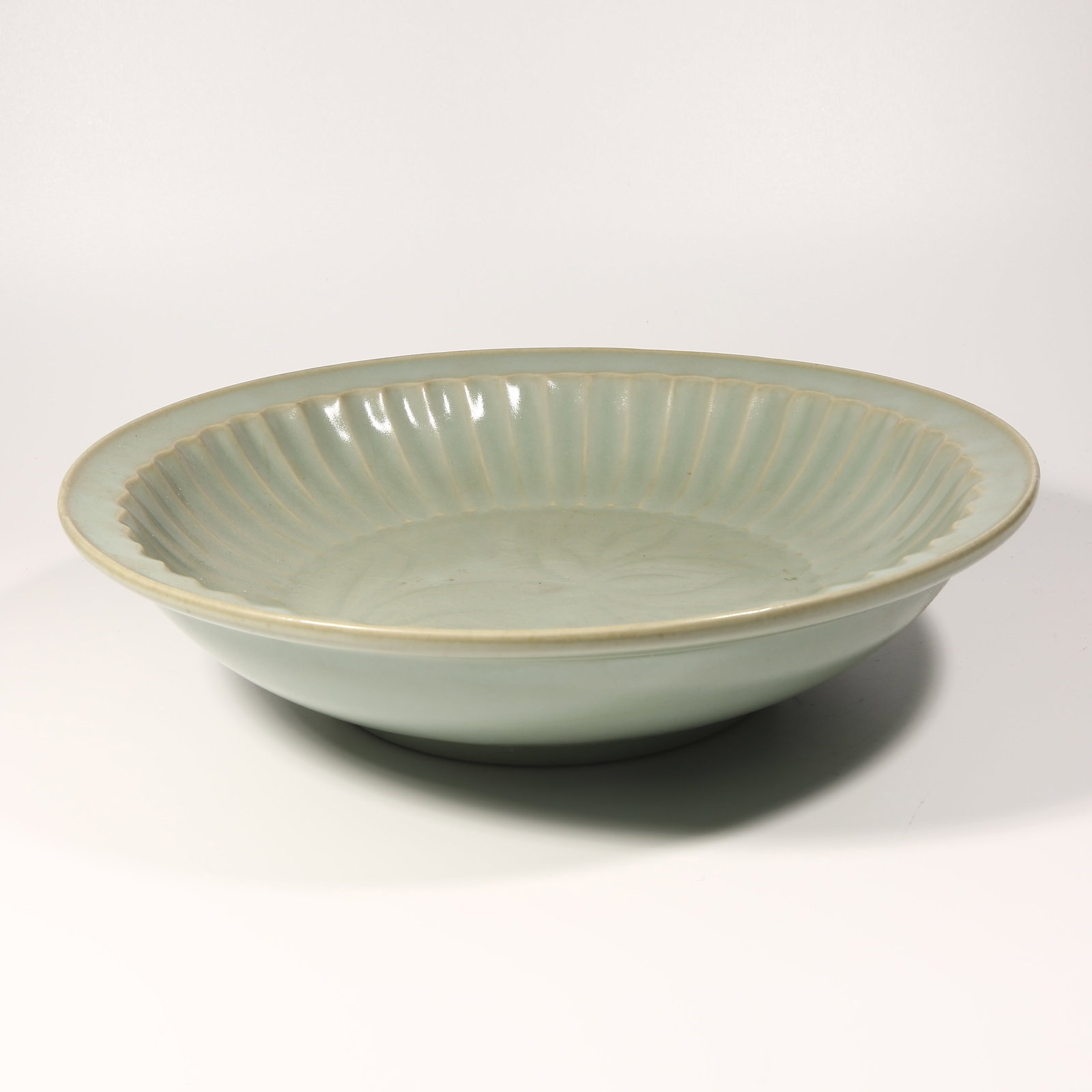 A LONGQUAN KILN FOLDED-RIM PLATE: Longquan Kiln Folded-Rim Plate