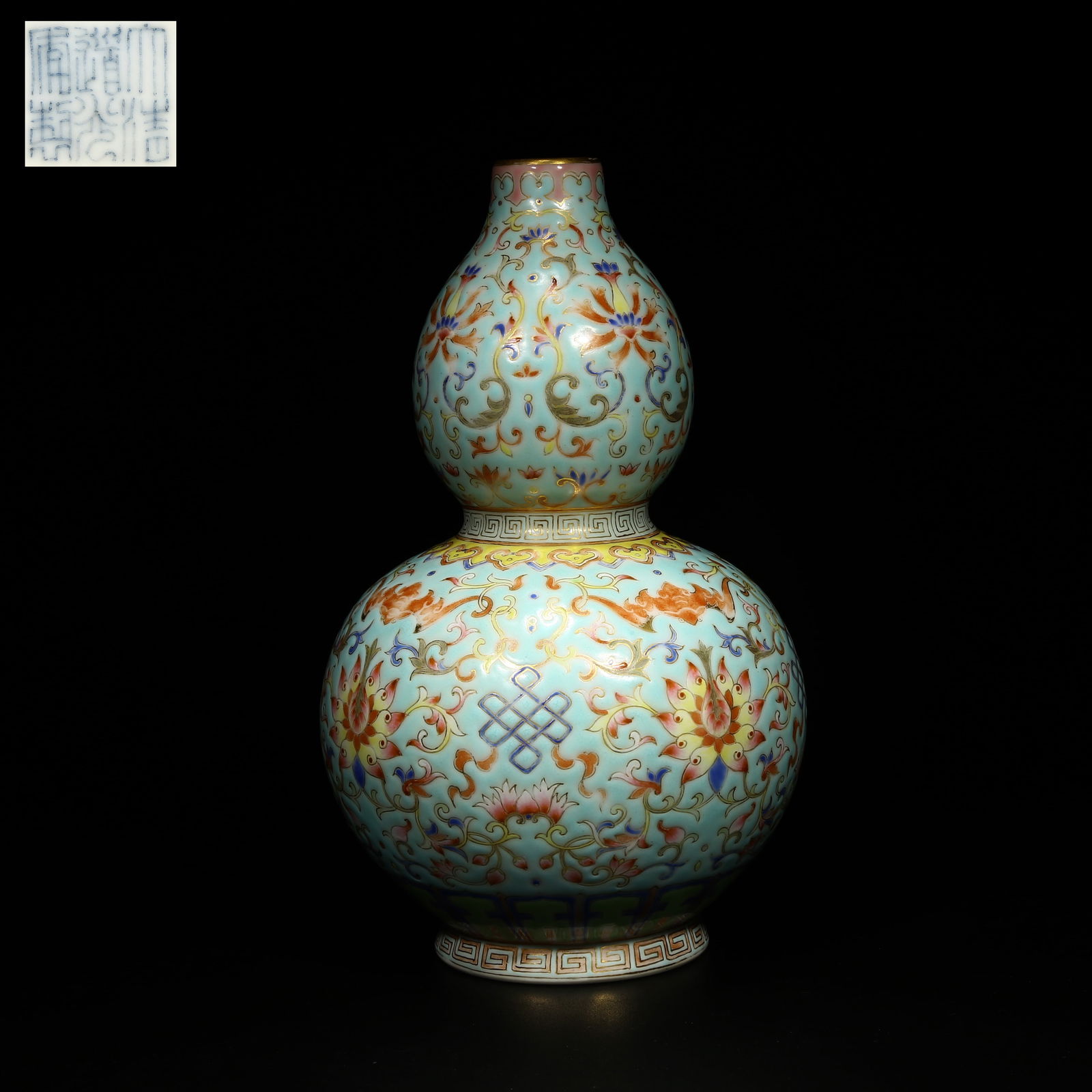 A TURQUOISE-GROUND FAMILLE ROSE GOURD VASE WITH ENTWINED LOTUS SCROLL DESIGN: Turquoise-ground famille rose gourd vase with entwined lotus scroll design