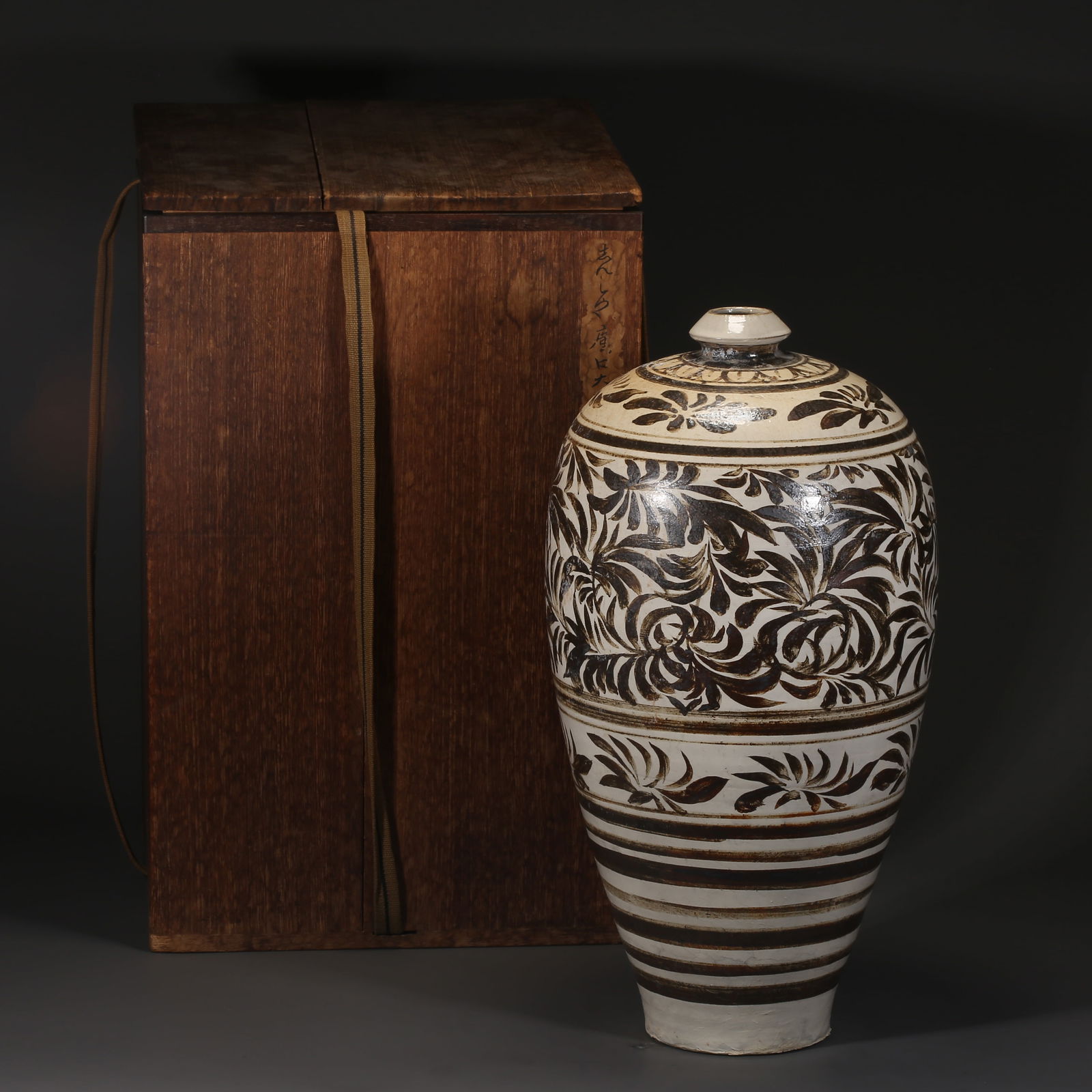 A CIZHOU KILN WHITE-GROUND BLACK-FLOWER PLUM-PATTERN VASE: Cizhou kiln white-ground black-flower plum-pattern vase