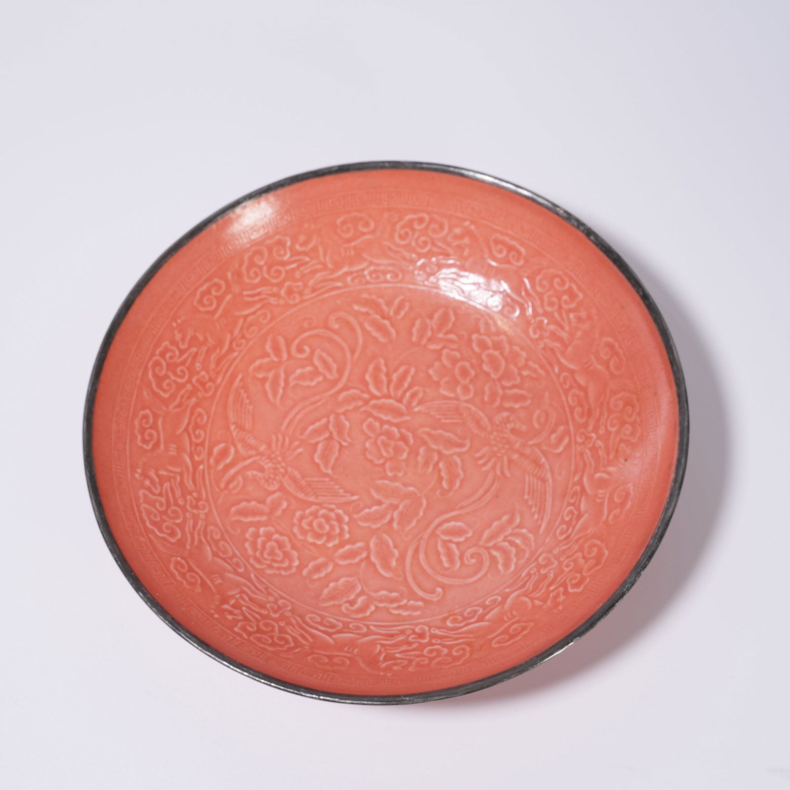 A RED-GLAZED DISH WITH BIRD-AND-FLOWER DESIGN: Red-glazed dish with bird-and-flower design