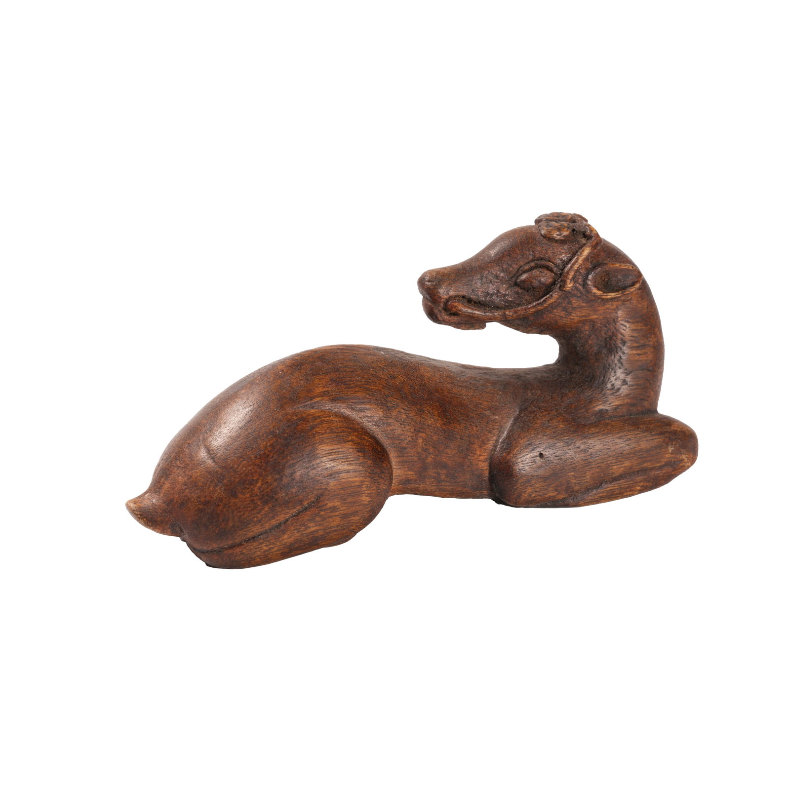 AGARWOOD PAPERWEIGHT IN LYING DEER SHAPE, QING DYNASTY: Crafted from a single whole agarwood block through full-round carving, this ornament is shaped into a recumbent deer plump and sleek in posture with smooth concise lines. Its head turns slightly with 