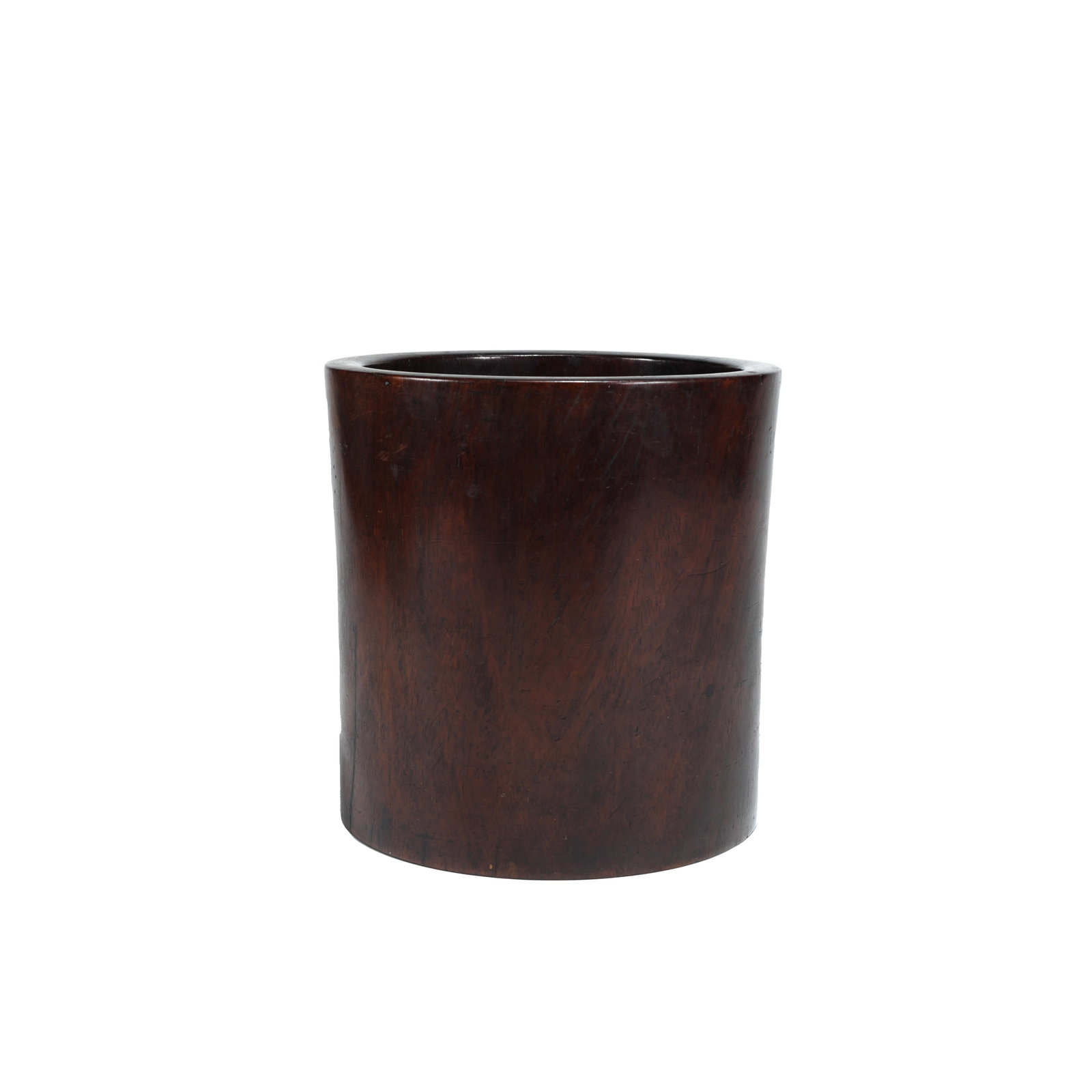PLAIN HUANGHUALI WOOD BRUSH POT, QING DYNASTY: This brush pot is made of premium yellow pear wood and hollowed out from a single whole timber. Crafted into a cylindrical shape with concise and vigorous lines, it represents the classic style of Qin