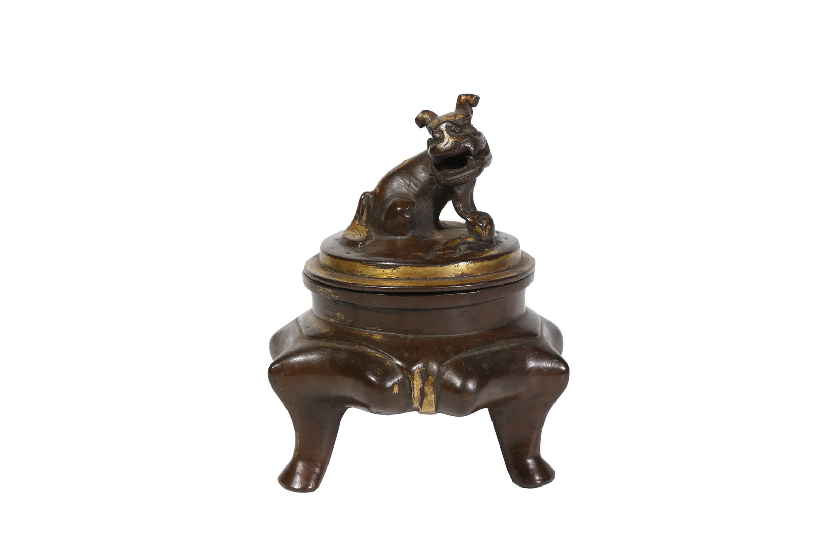 GILT LACQUERED BRONZE TRIPOD INCENSE BURNER WITH LION KNOB, QING DYNASTY: This lacquer-gilded bronze incense burner features a squatting lion-shaped knob on its round lid. The lion opens its mouth wide with paws resting on a silk ball in a vivid pose, which also serves as s