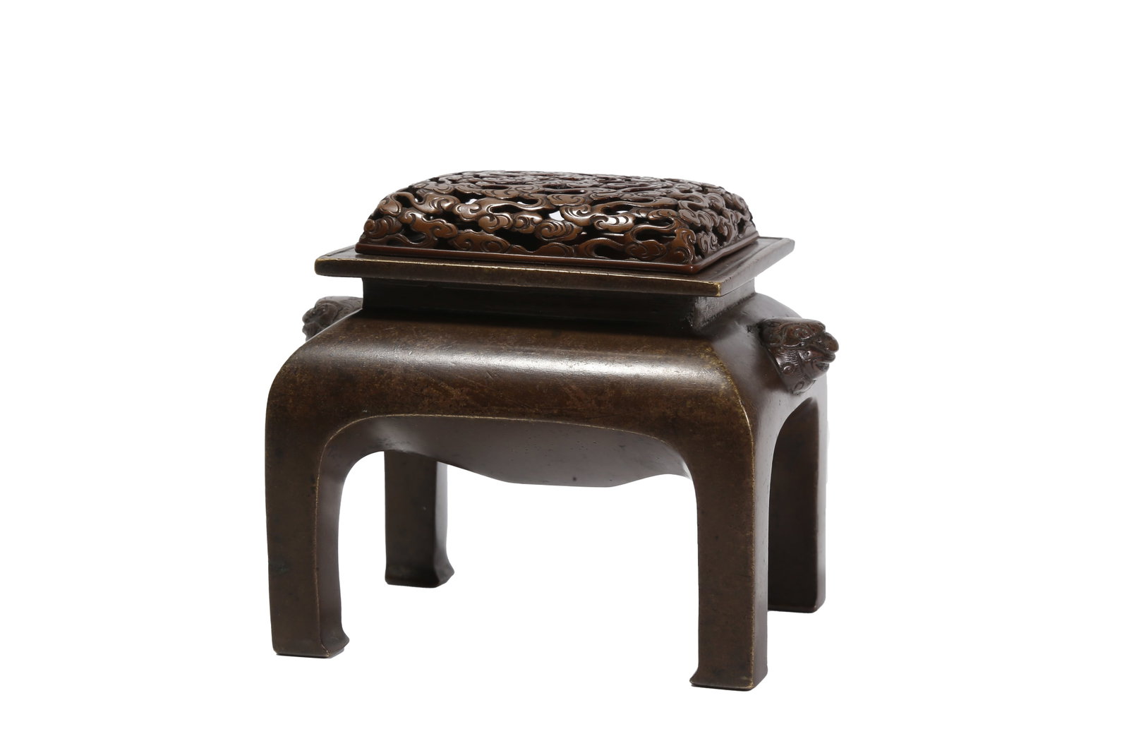 FOUR-LEGGED BRONZE INCENSE BURNER WITH CLOUD PATTERNS AND BEAST EARS, QING DYNASTY: This Qing Dynasty bronze incense burner is made in imitation of Xuande style. Cast from fine bronze, it is designed into a rounded square high-foot shape fitted with an openwork cloud-patterned cover,