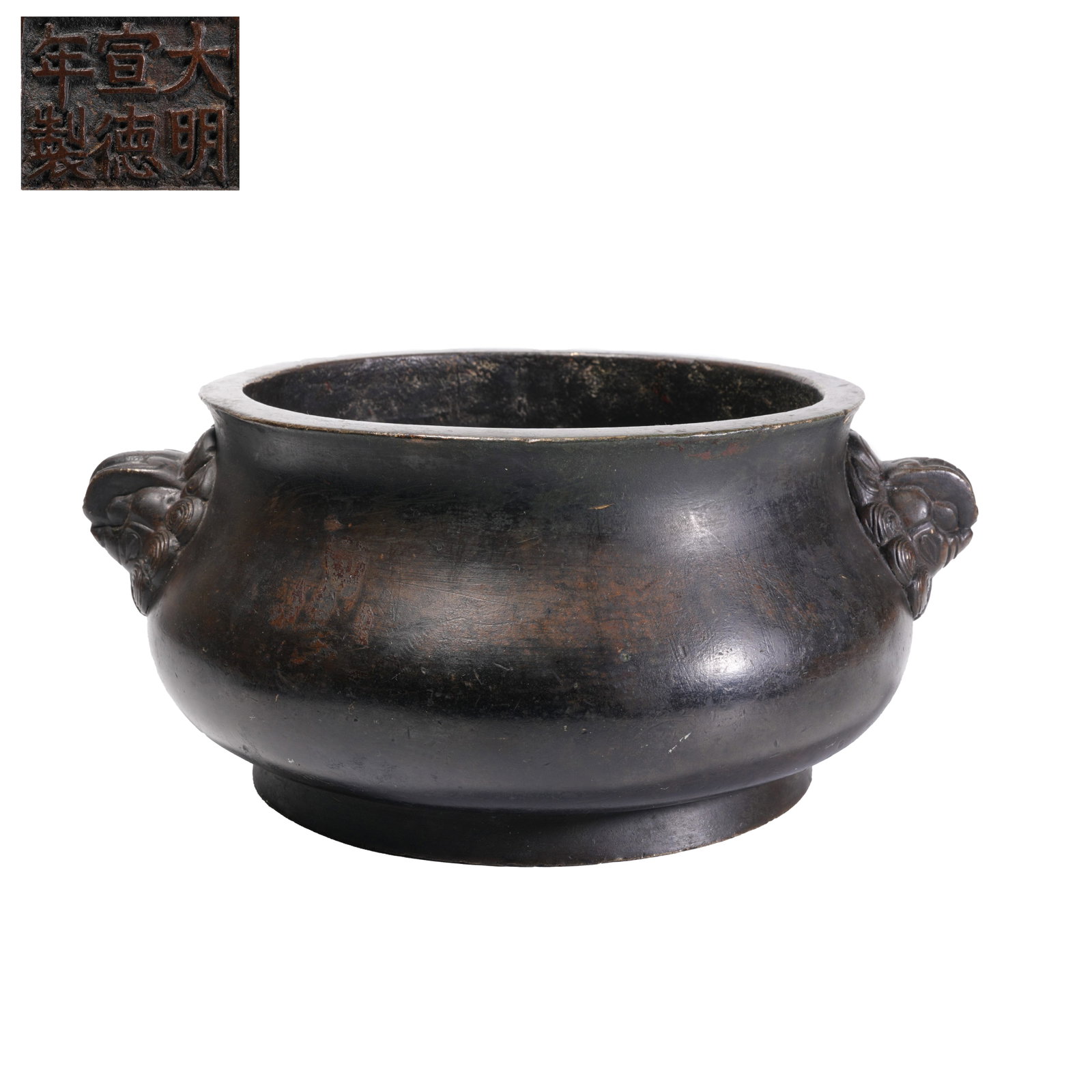 BRONZE CELESTIAL PIVOT CENSER, QING DYNASTY: This is an exemplary Qing Dynasty scholarly bronze censer crafted in classic Tianji style, fitted with twin lion-head ears and beast-head ring ornaments. Well-proportioned in shape and covered with st